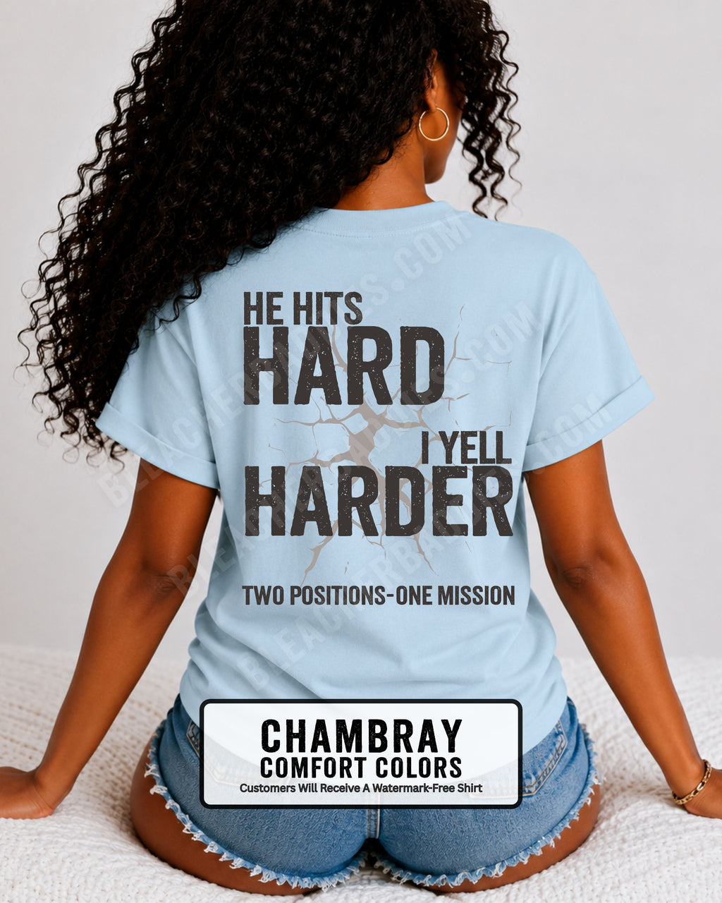 Back view of a chambray blue Comfort Colors t-shirt featuring the distressed "He Hits Hard I Yell Harder" football design with "Two Positions One Mission" printed across the lower back. Football mom shirt.