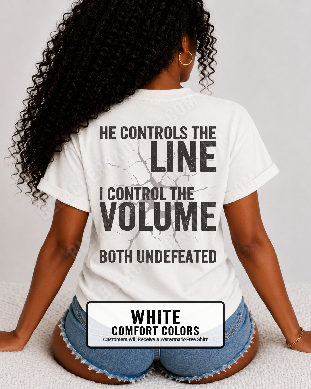 Back view of woman wearing WHITE Comfort Colors football mom game day shirt featuring “He Controls the Line I Control the Volume Both Undefeated” bold graphic design. Lineman mom shirt. 