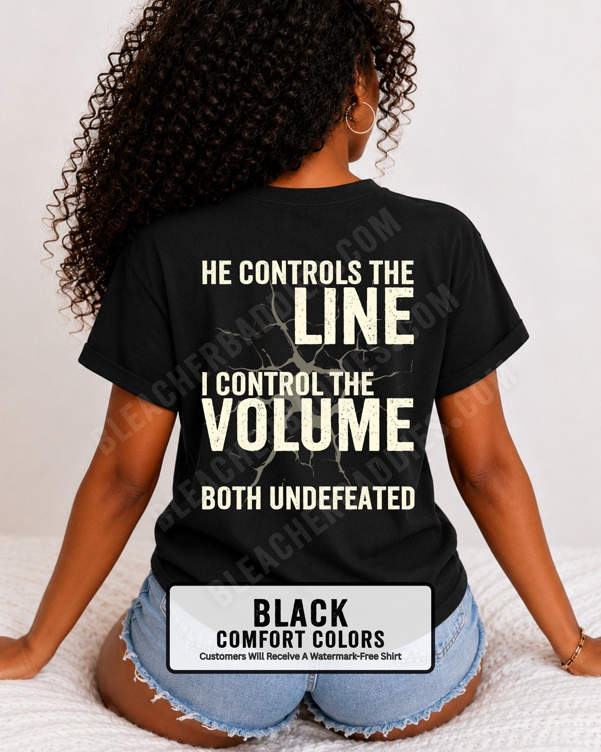 Back view of woman wearing black Comfort Colors football mom game day shirt featuring “He Controls the Line I Control the Volume Both Undefeated” bold graphic design