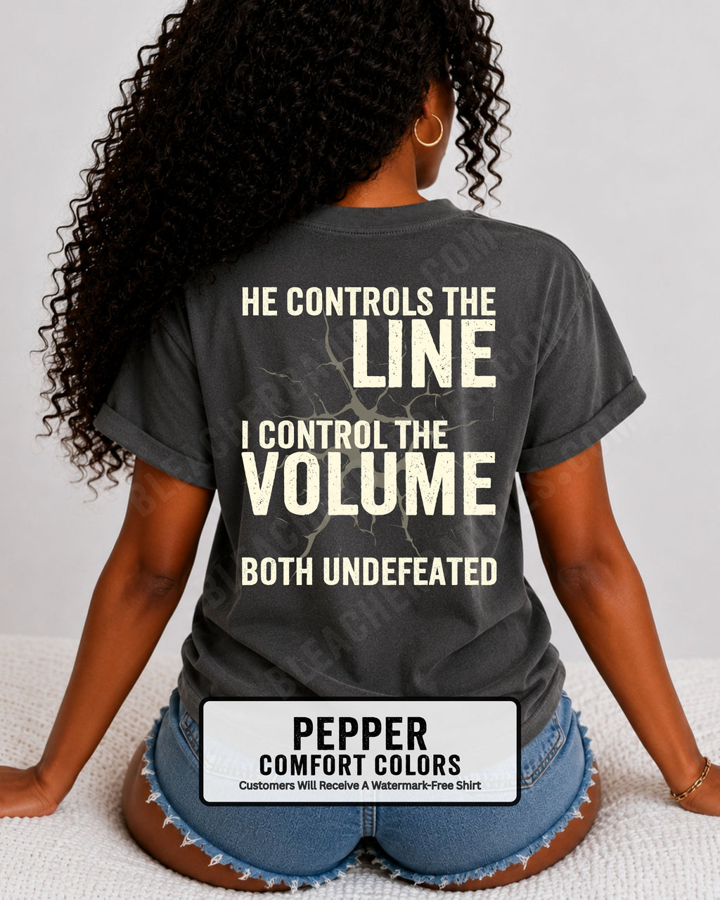 Back view of woman wearing pepper Comfort Colors football mom game day shirt featuring “He Controls the Line I Control the Volume Both Undefeated” bold graphic design
