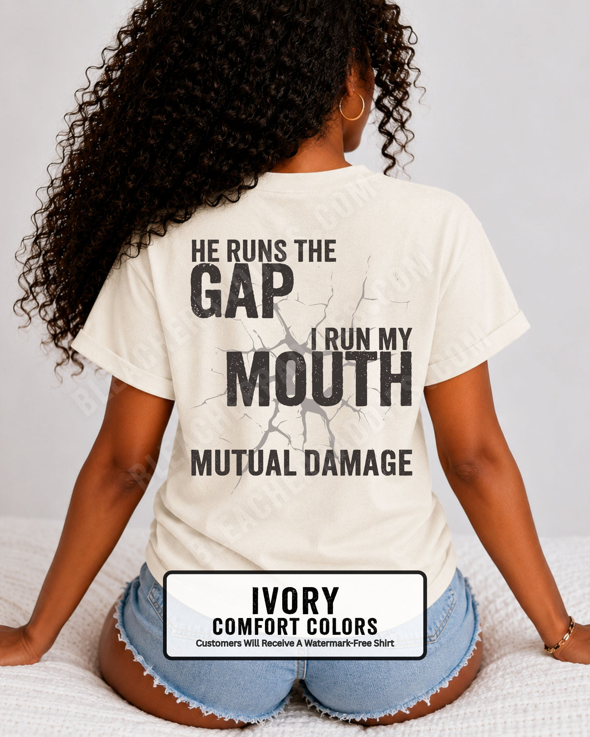 Back view of football mom wearing ivory Comfort Colors game day shirt with “He Runs the Gap I Run My Mouth Mutual Damage” graphic design