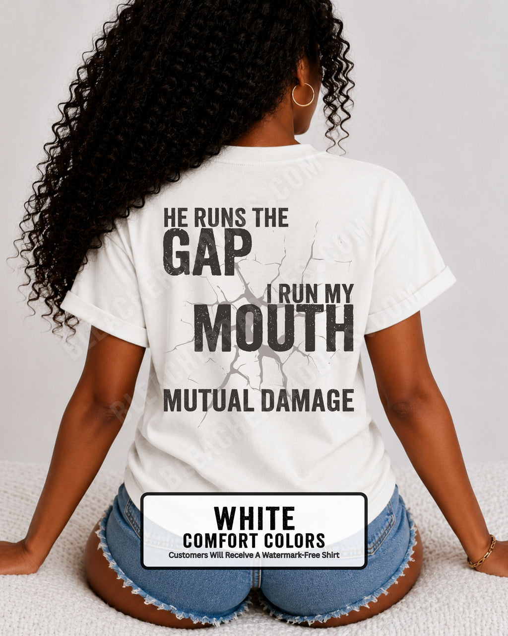 Back view of football mom wearing white Comfort Colors game day shirt with “He Runs the Gap I Run My Mouth Mutual Damage” graphic design
