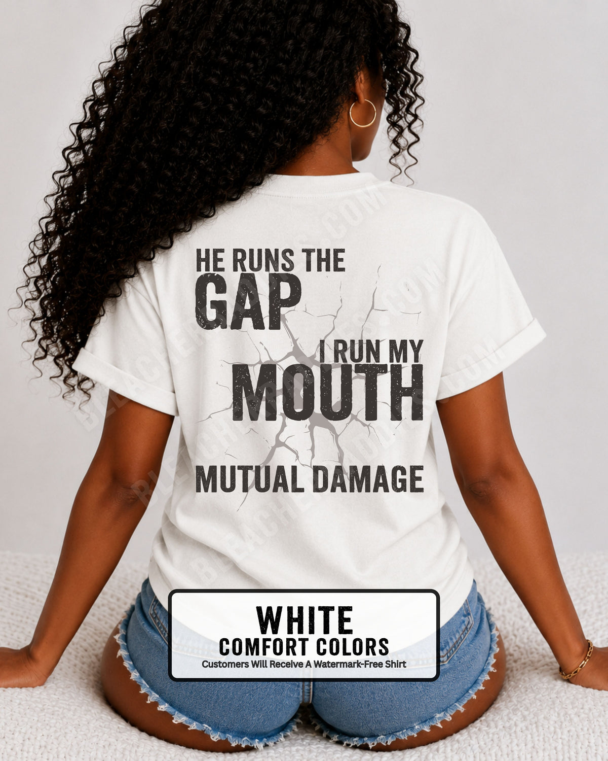 Back view of football mom wearing white Comfort Colors game day shirt with “He Runs the Gap I Run My Mouth Mutual Damage” graphic design