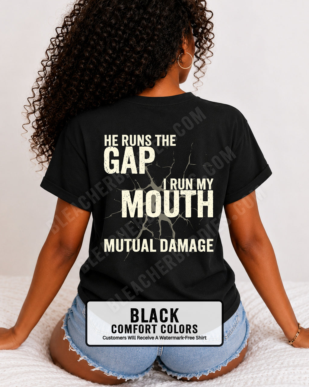 Back view of football mom wearing black Comfort Colors game day shirt with “He Runs the Gap I Run My Mouth Mutual Damage” graphic design