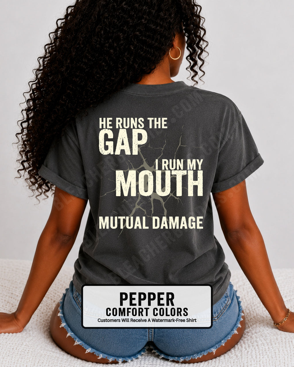 Back view of football mom wearing pepper Comfort Colors game day shirt with “He Runs the Gap I Run My Mouth Mutual Damage” graphic design