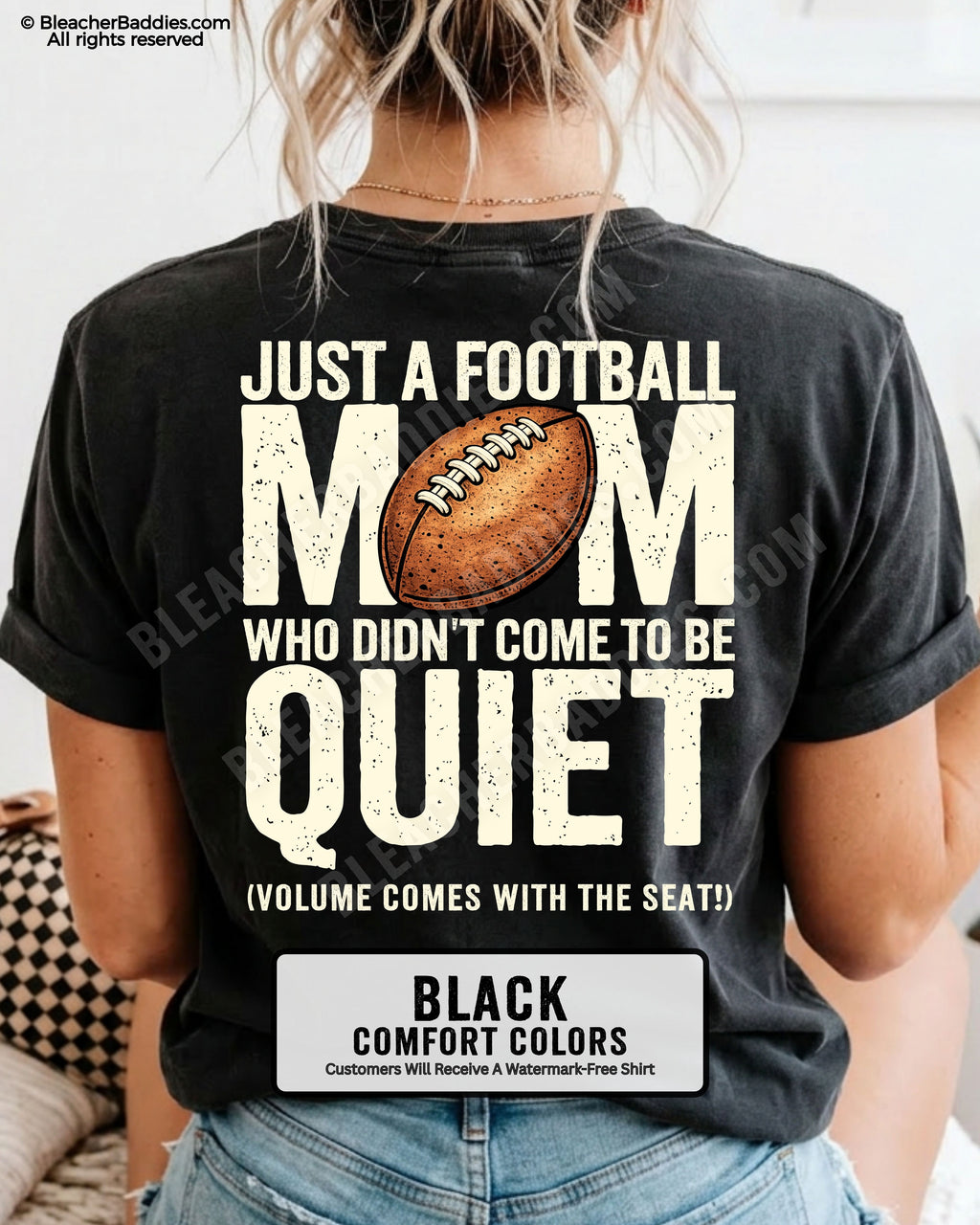 Football mom game day shirt on black Comfort Colors tee featuring bold back graphic that reads “Just a football mom who didn’t come to be quiet volume comes with the seat”