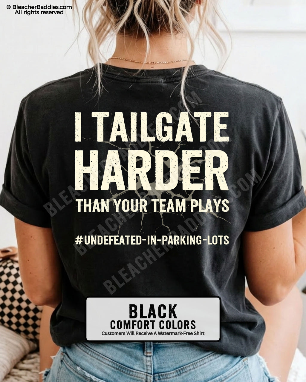 Woman wearing BLACK Comfort Colors football mom game day shirt with back design that reads “I tailgate harder than your team plays #undefeated-in-parking-lots” in distressed CREAM text with cracked graphic and chambray color label shown