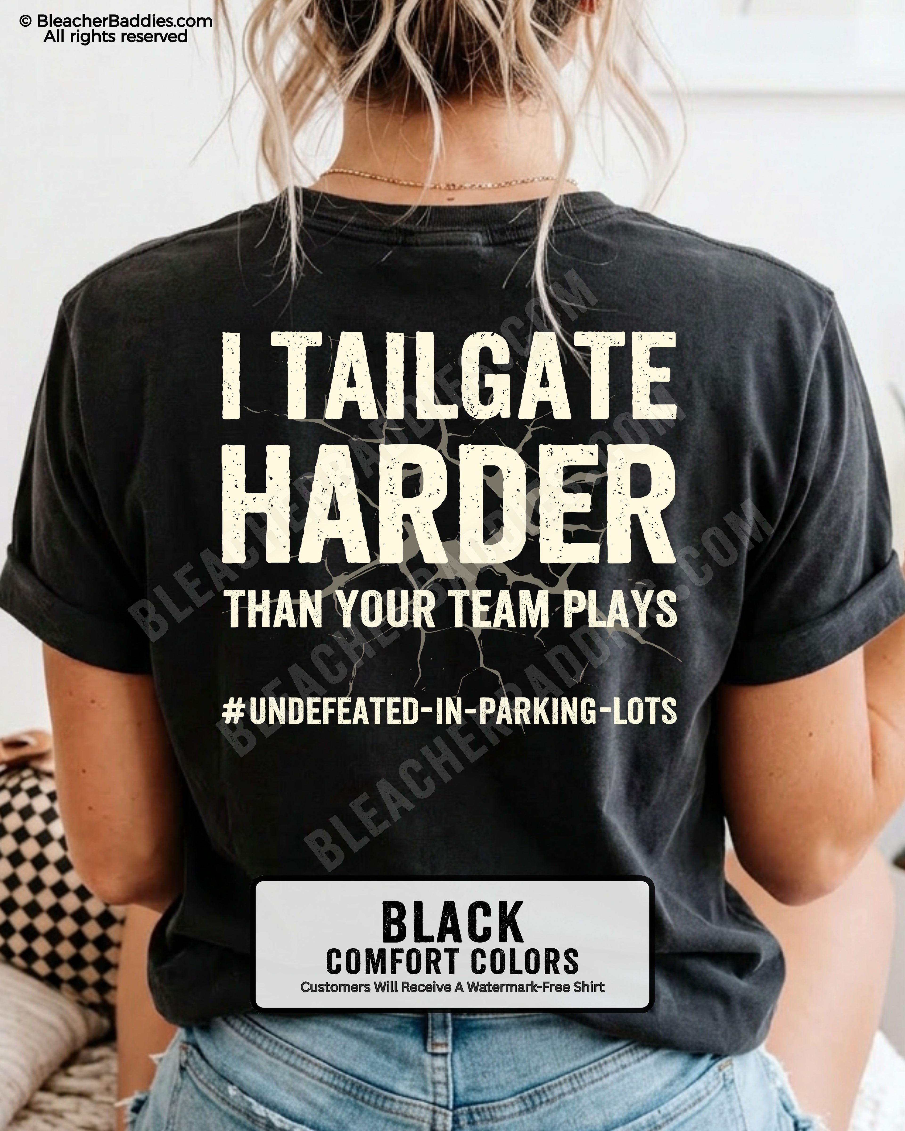 Woman wearing BLACK Comfort Colors football mom game day shirt with back design that reads “I tailgate harder than your team plays #undefeated-in-parking-lots” in distressed CREAM text with cracked graphic and chambray color label shown