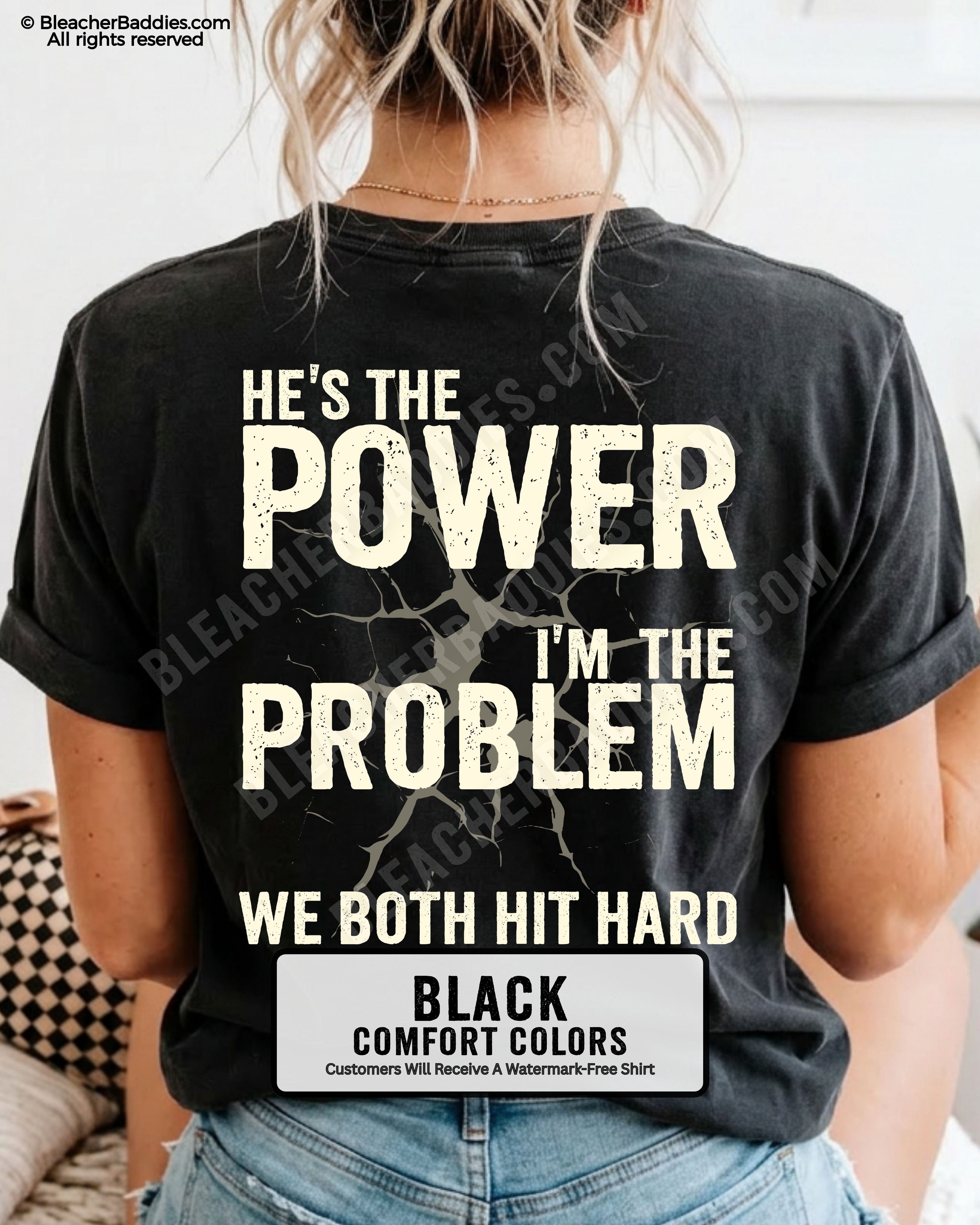 Back view of black Comfort Colors football mom game day shirt reading “He’s the Power I’m the Problem We Both Hit Hard,” close-up fit on woman wearing denim shorts