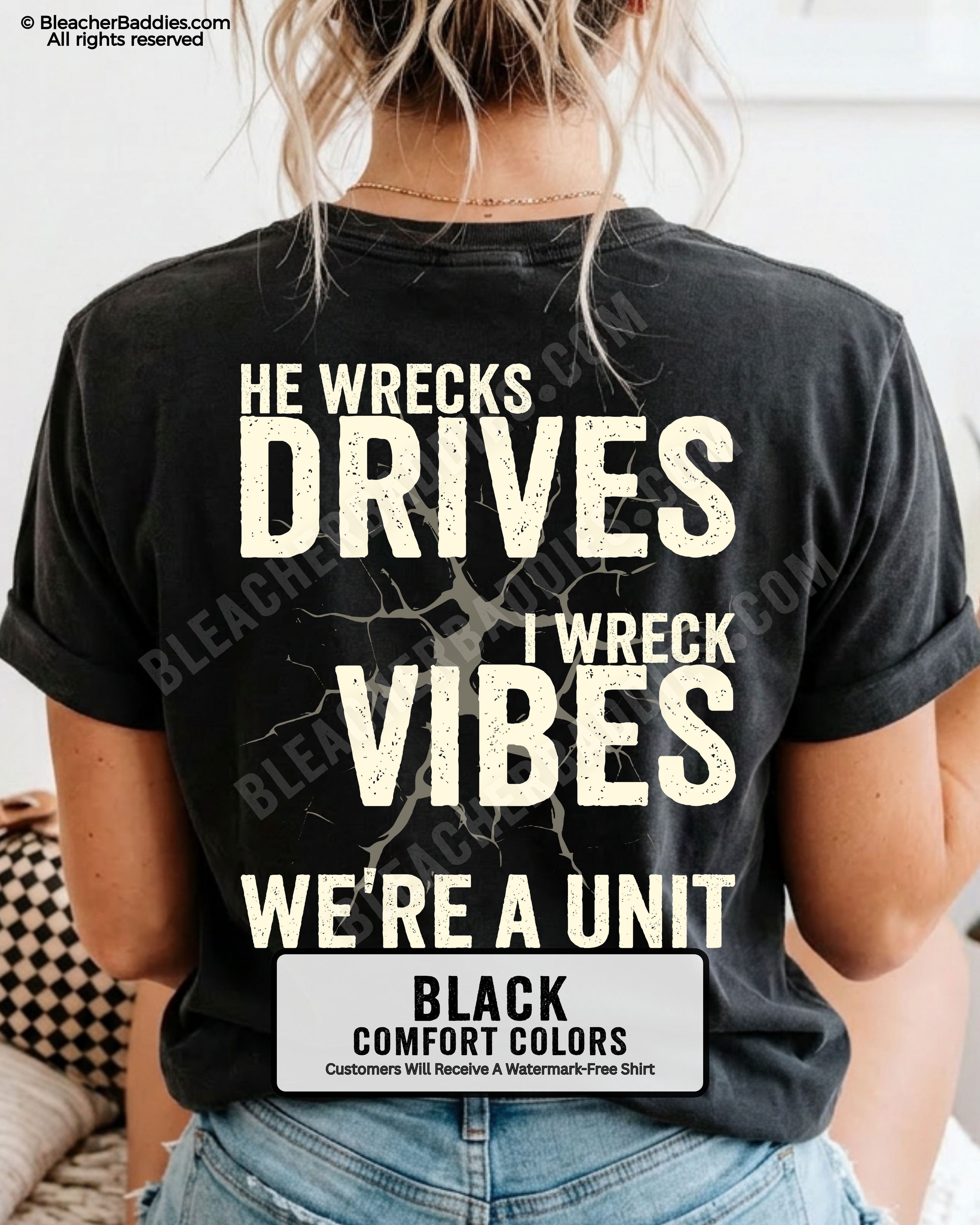 Woman wearing a black Comfort Colors t-shirt shown from the back featuring a large distressed cream graphic that reads “He Wrecks Drives I Wreck Vibes We’re a Unit.”