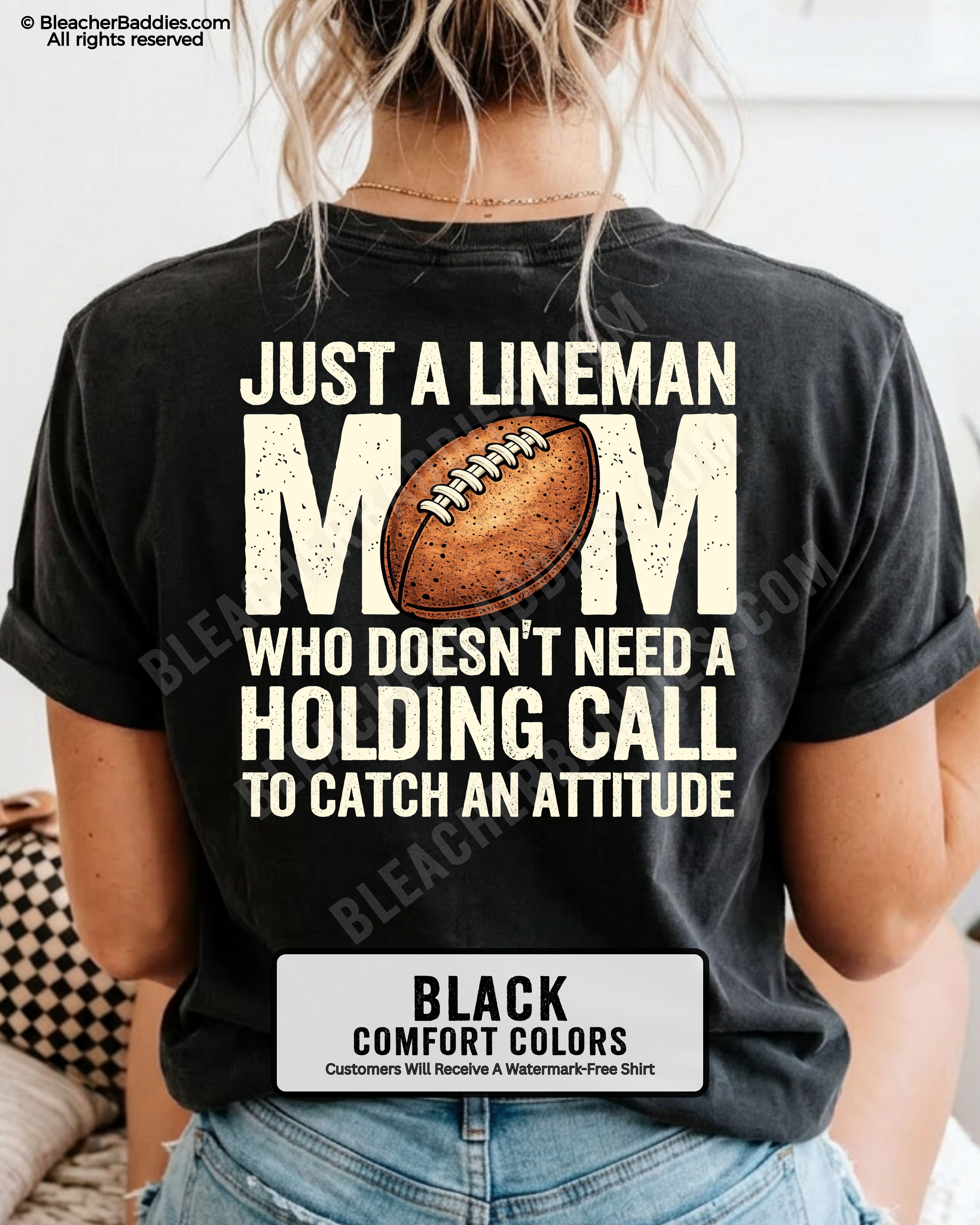 back view of woman wearing a black Comfort Colors lineman mom football shirt featuring bold back design that says “Just a lineman mom who doesn’t need a holding call to catch an attitude”