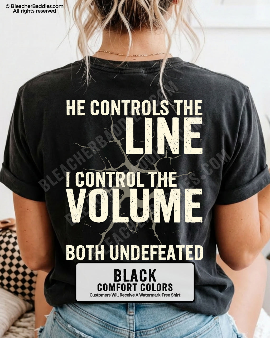 Back view of woman wearing BLACK Comfort Colors football mom game day shirt featuring “He Controls the Line I Control the Volume Both Undefeated” bold graphic design