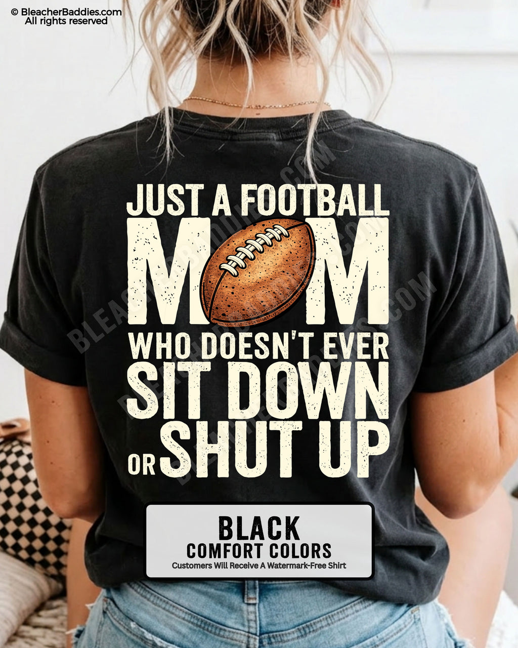 Black Comfort Colors t-shirt shown from back with oversized graphic text “Just a Football Mom Who Doesn’t Ever Sit Down or Shut Up” and football illustration