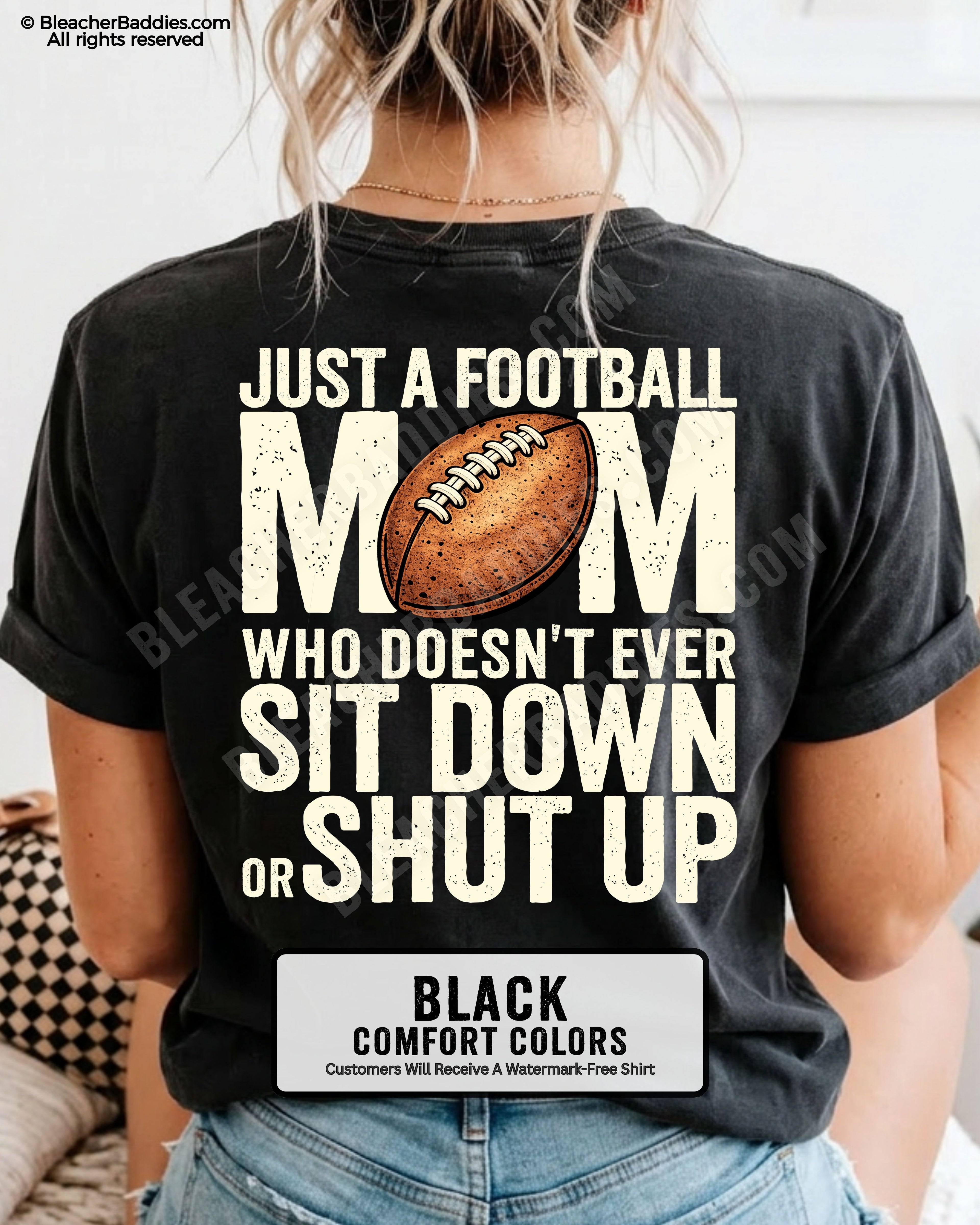 Black Comfort Colors t-shirt shown from back with oversized graphic text “Just a Football Mom Who Doesn’t Ever Sit Down or Shut Up” and football illustration