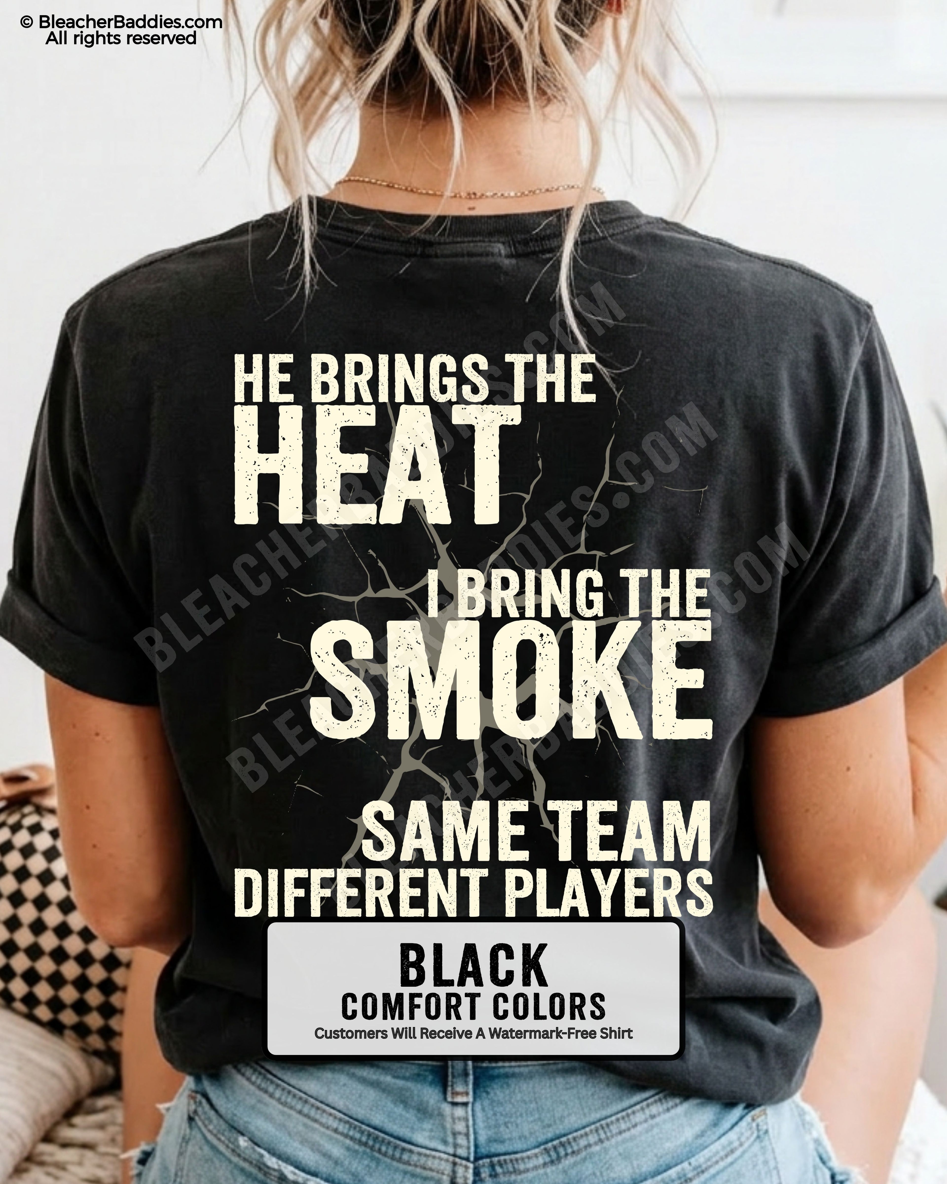 Close-up of BLACK COMFORT COLORS FOOTBALL MOM t-shirt back print showing distressed text “He Brings the Heat I Bring the Smoke Same Team Different Players” with cracked design detail
