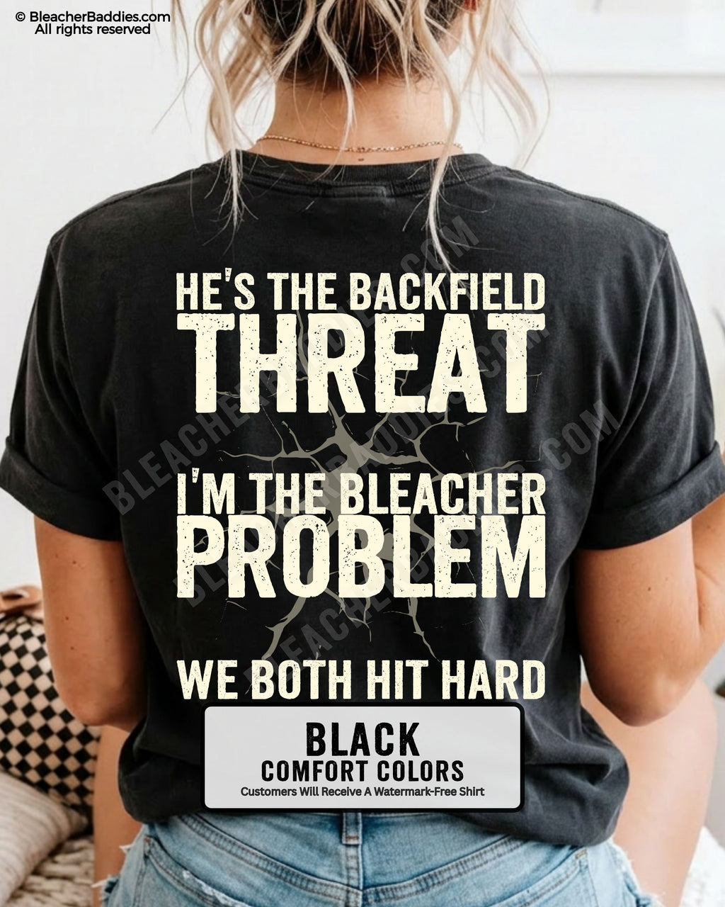 Back view of football mom wearing BLACK Comfort Colors game day shirt with “He’s the Backfield Threat I’m the Bleacher Problem We Both Hit Hard” graphic design