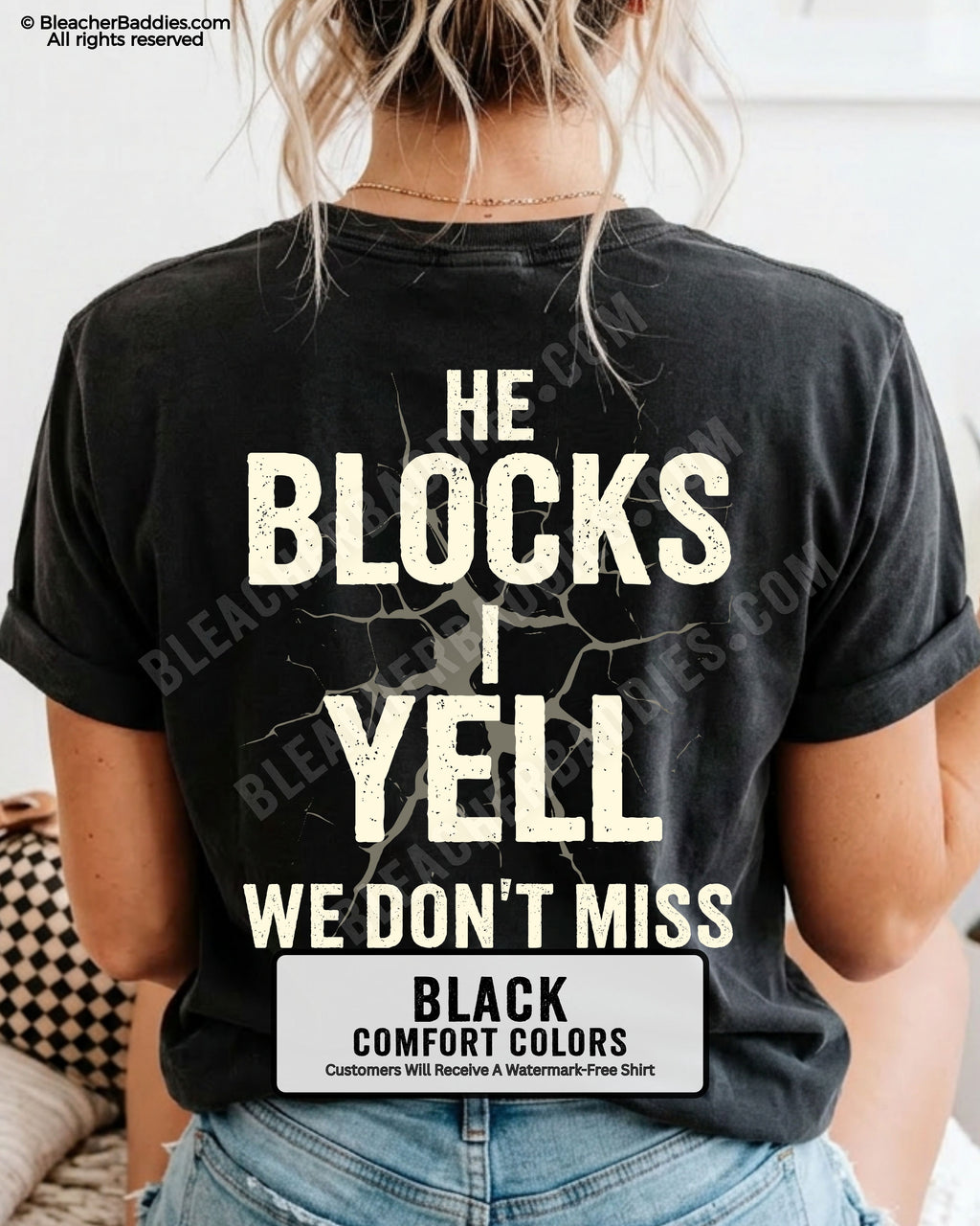 Woman wearing BLACK Comfort Colors football mom game day shirt with back design that reads “He blocks I yell we don’t miss” in distressed CREAM text with cracked graphic and ivory color label shown