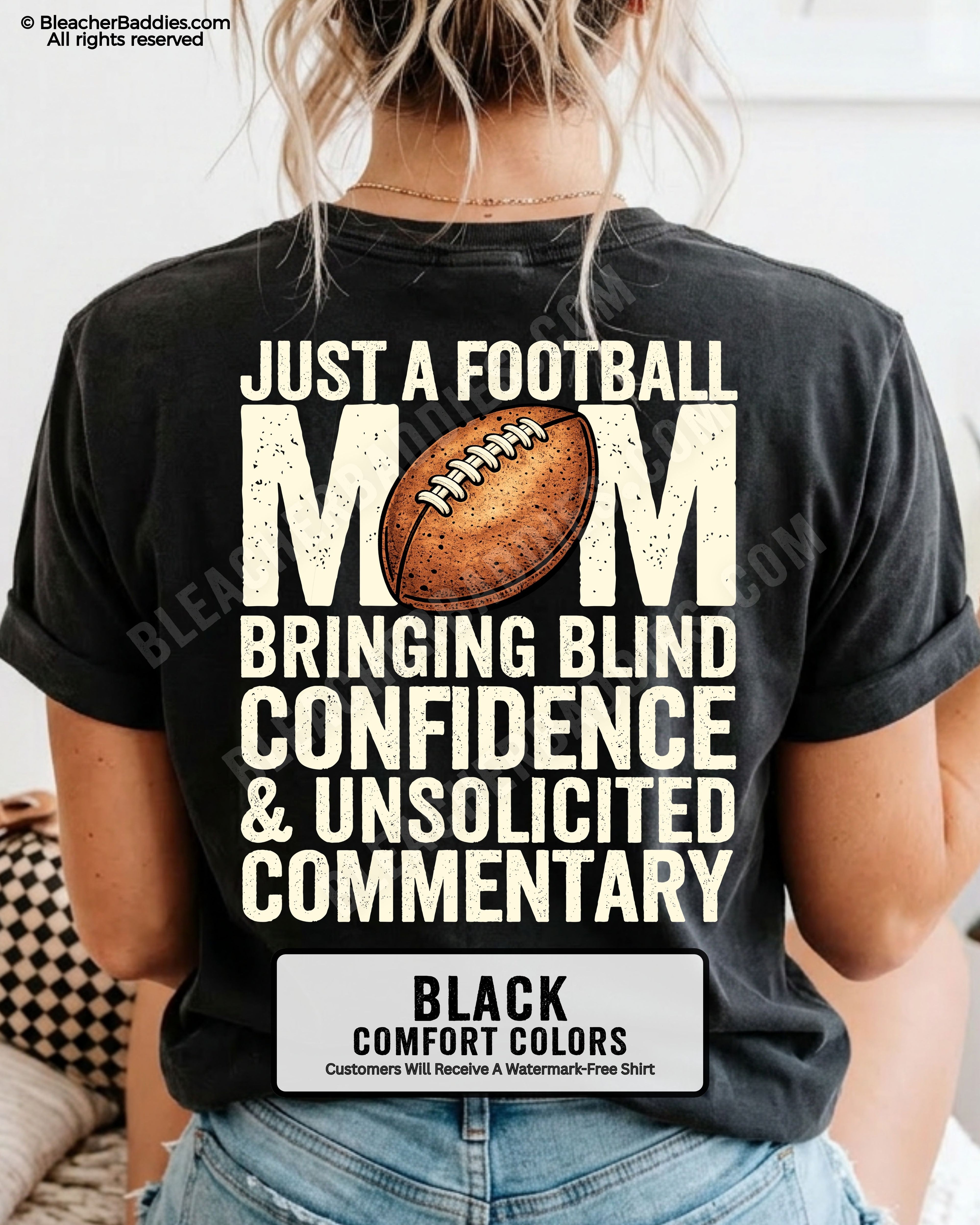 Black Comfort Colors t-shirt worn by woman showing back graphic reading “Just a football mom bringing blind confidence & unsolicited commentary” with football illustration