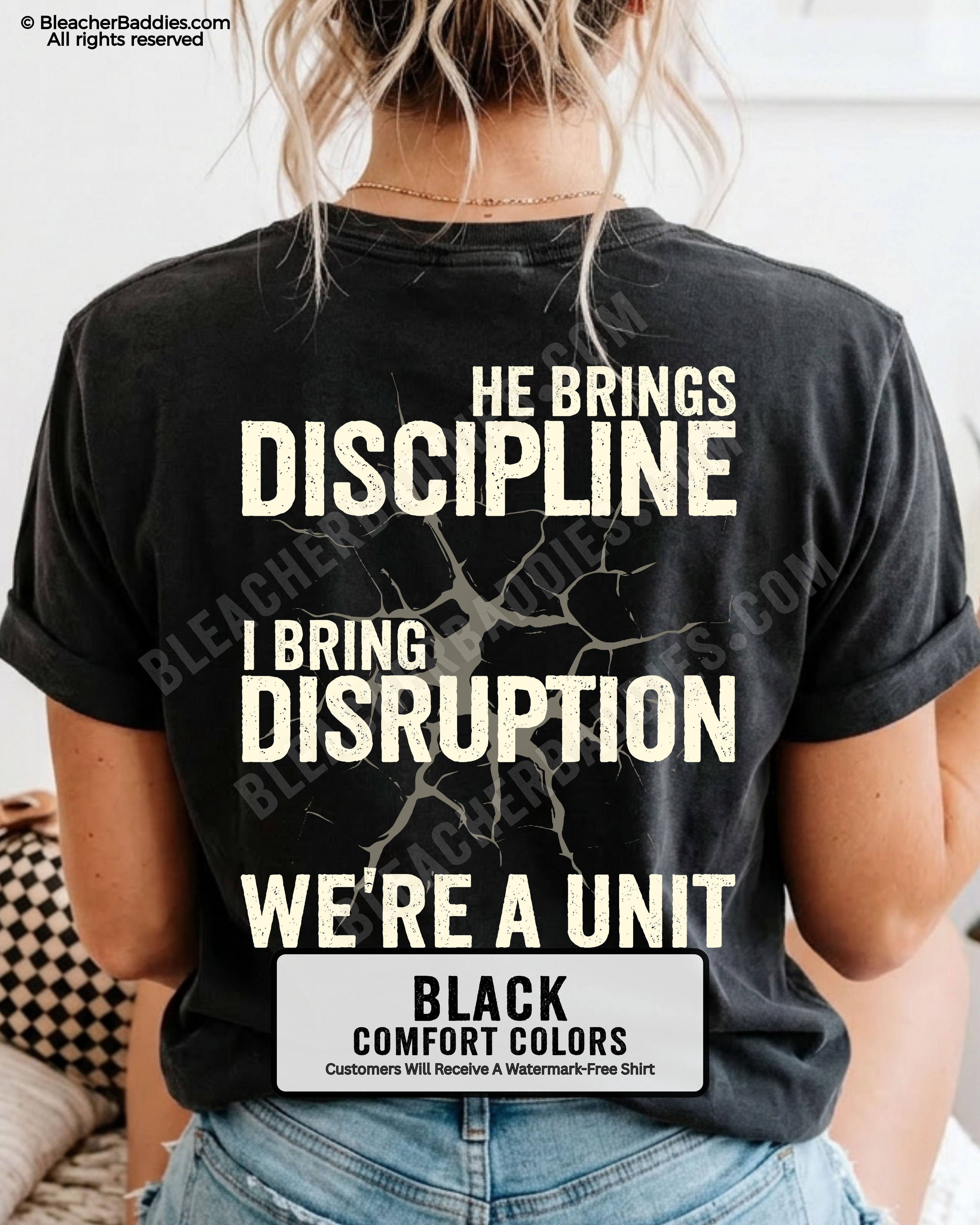 Back view of BLACK Comfort Colors football mom game day shirt featuring “He Brings Discipline I Bring Disruption We’re a Unit” design worn by woman indoors with denim shorts