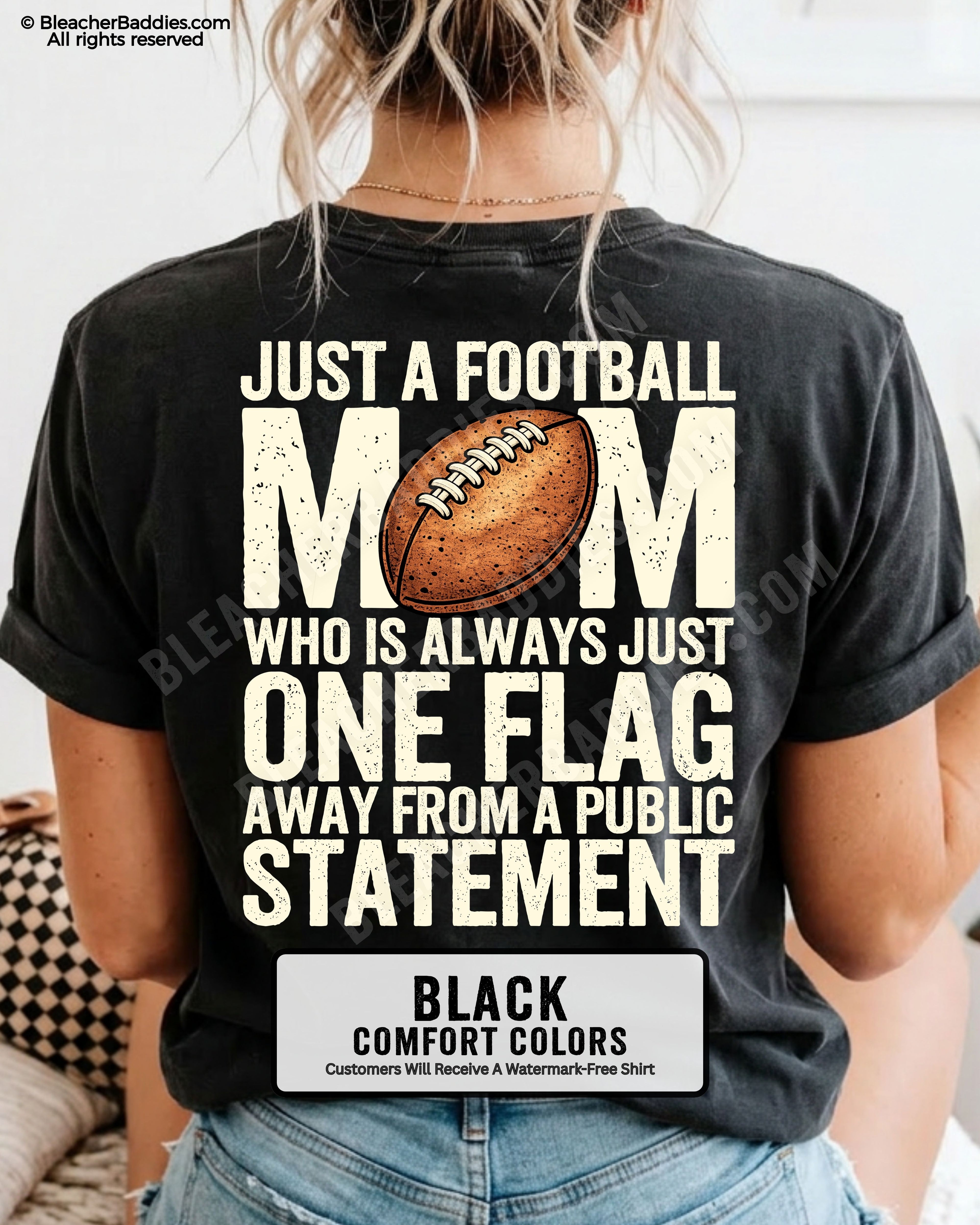 black comfort colors football mom game day shirt worn by model with back graphic that says just a football mom who is always just one flag away from a public statement
