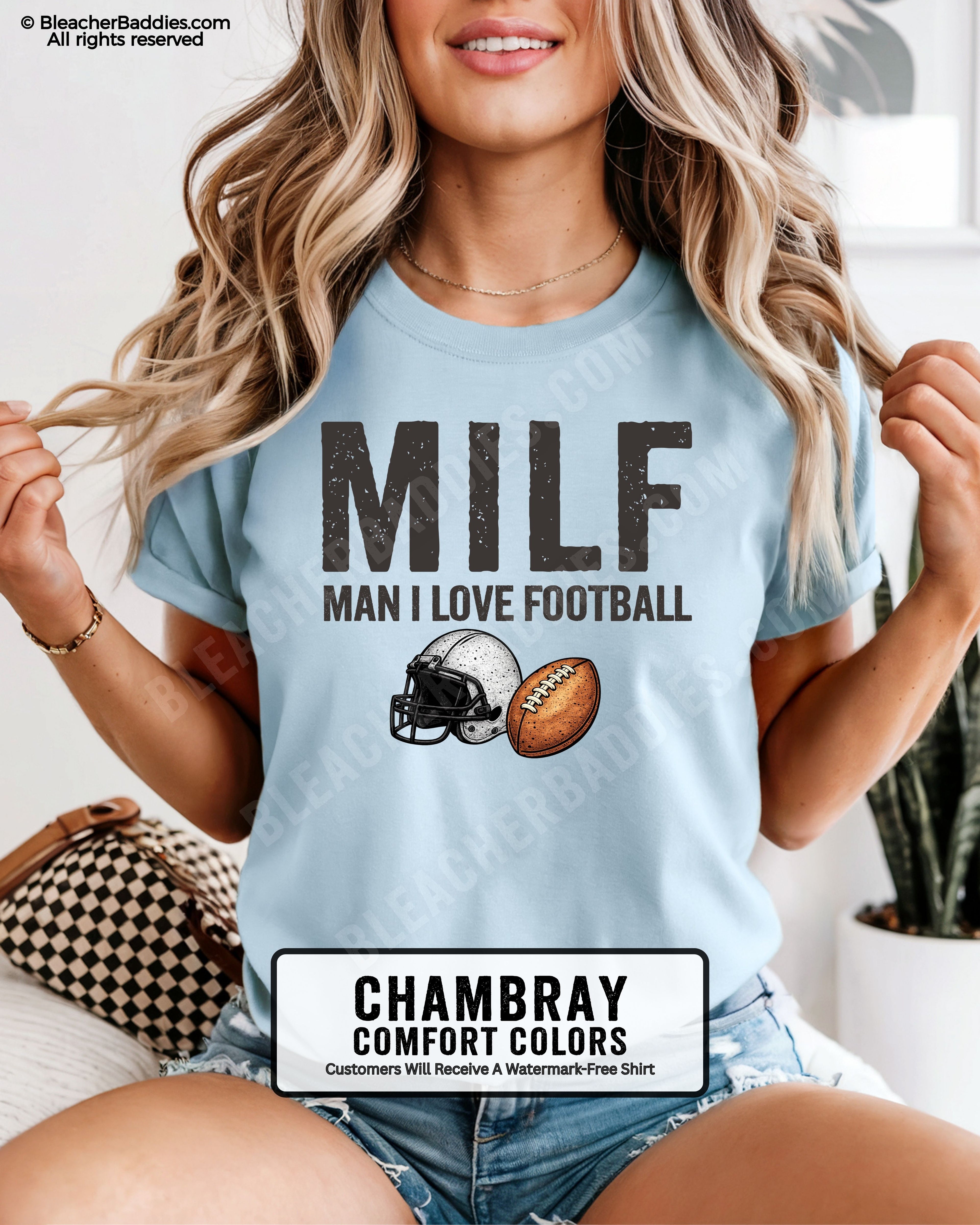 Woman wearing chambray comfort colors t-shirt that says “MILF Man I Love Football” with football helmet and ball graphic