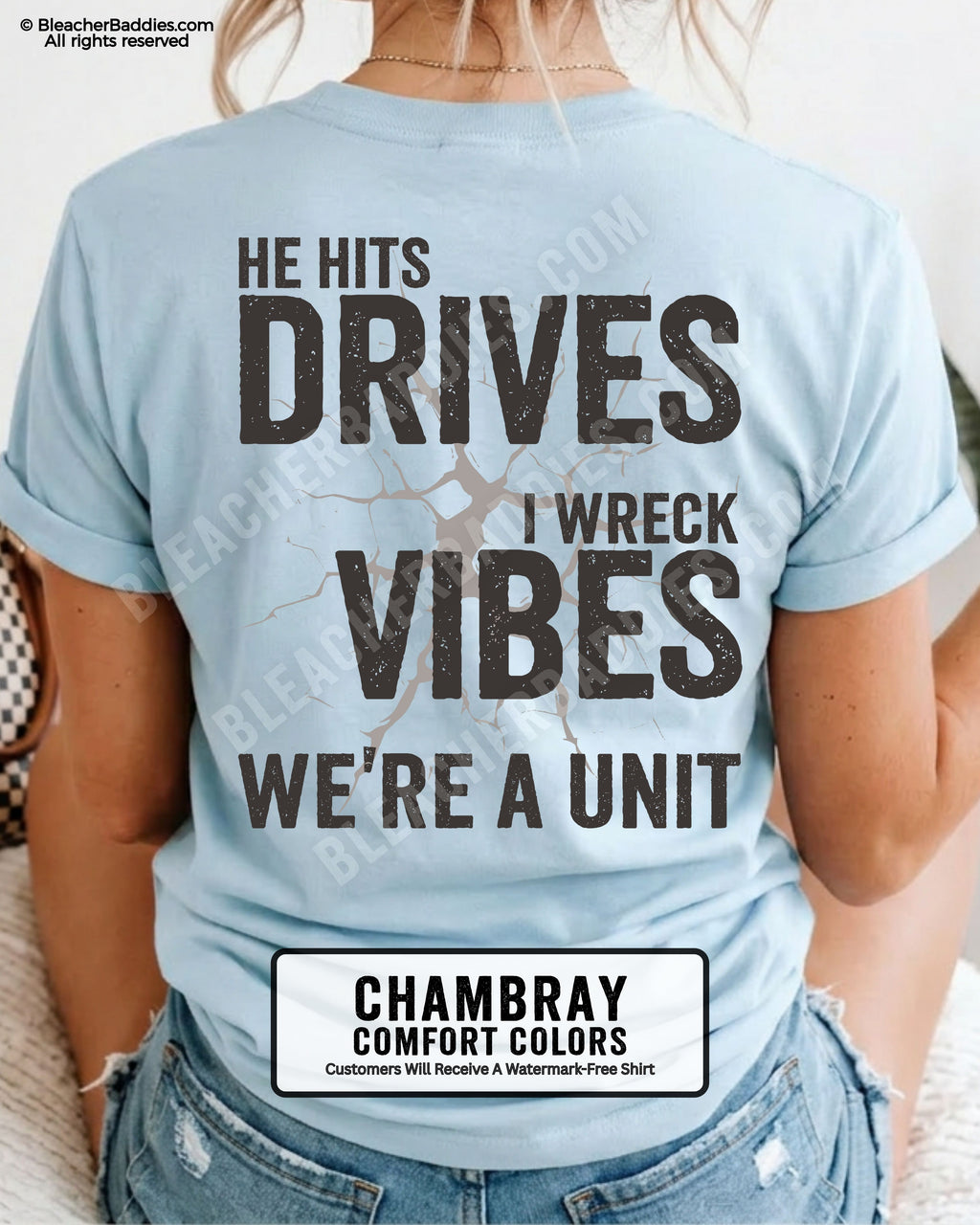 Chambray blue Comfort Colors baseball mom shirt featuring oversized distressed back graphic reading “He Hits Drives I Wreck Vibes We’re A Unit” with cracked background detail and vintage sports mom aesthetic.
