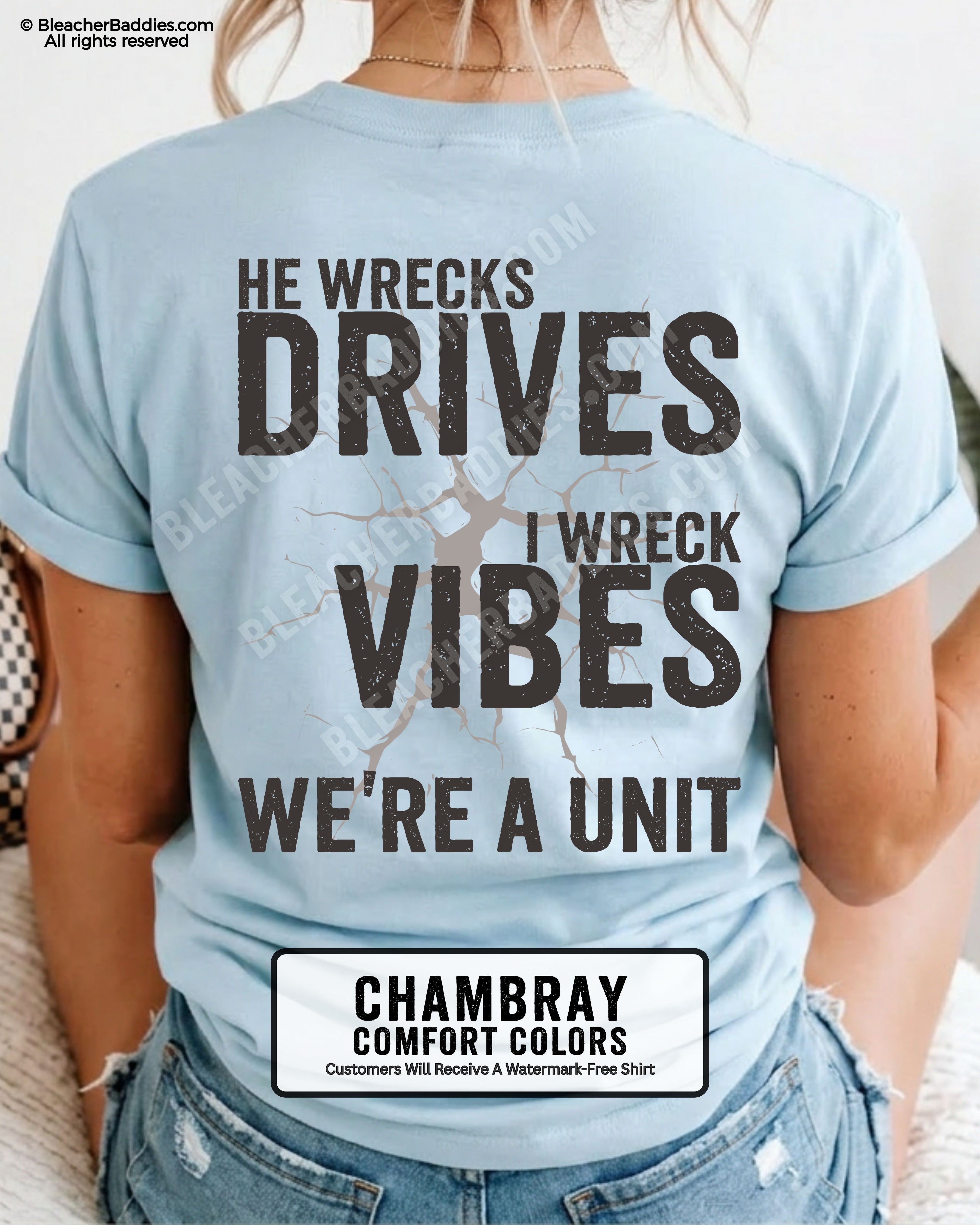 Woman wearing a chambray blue Comfort Colors t-shirt shown from the back featuring a large distressed black graphic that reads “He Wrecks Drives I Wreck Vibes We’re a Unit.”
