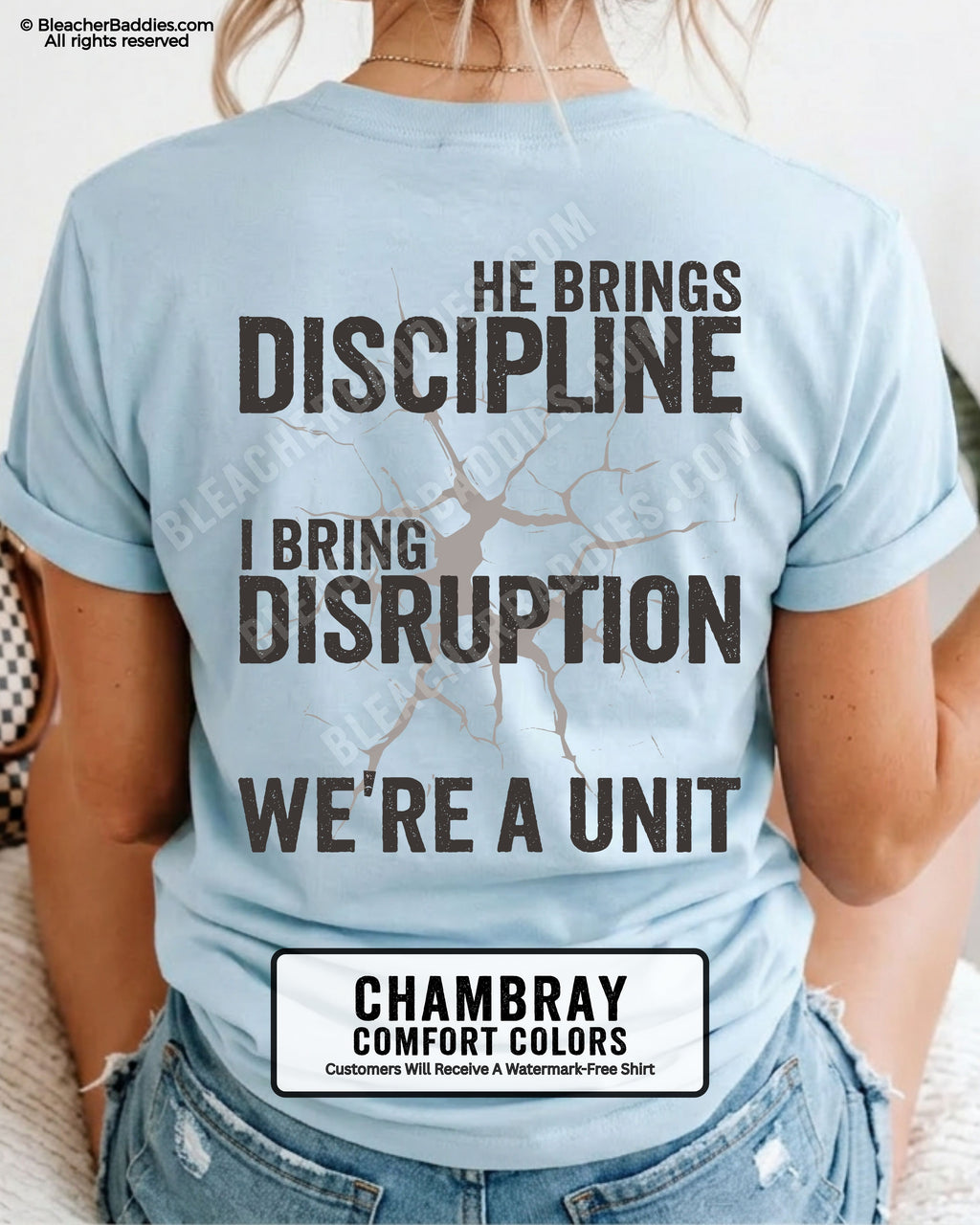 Back view of chambray Comfort Colors football mom game day shirt featuring “He Brings Discipline I Bring Disruption We’re a Unit” design worn by woman indoors with denim shorts
