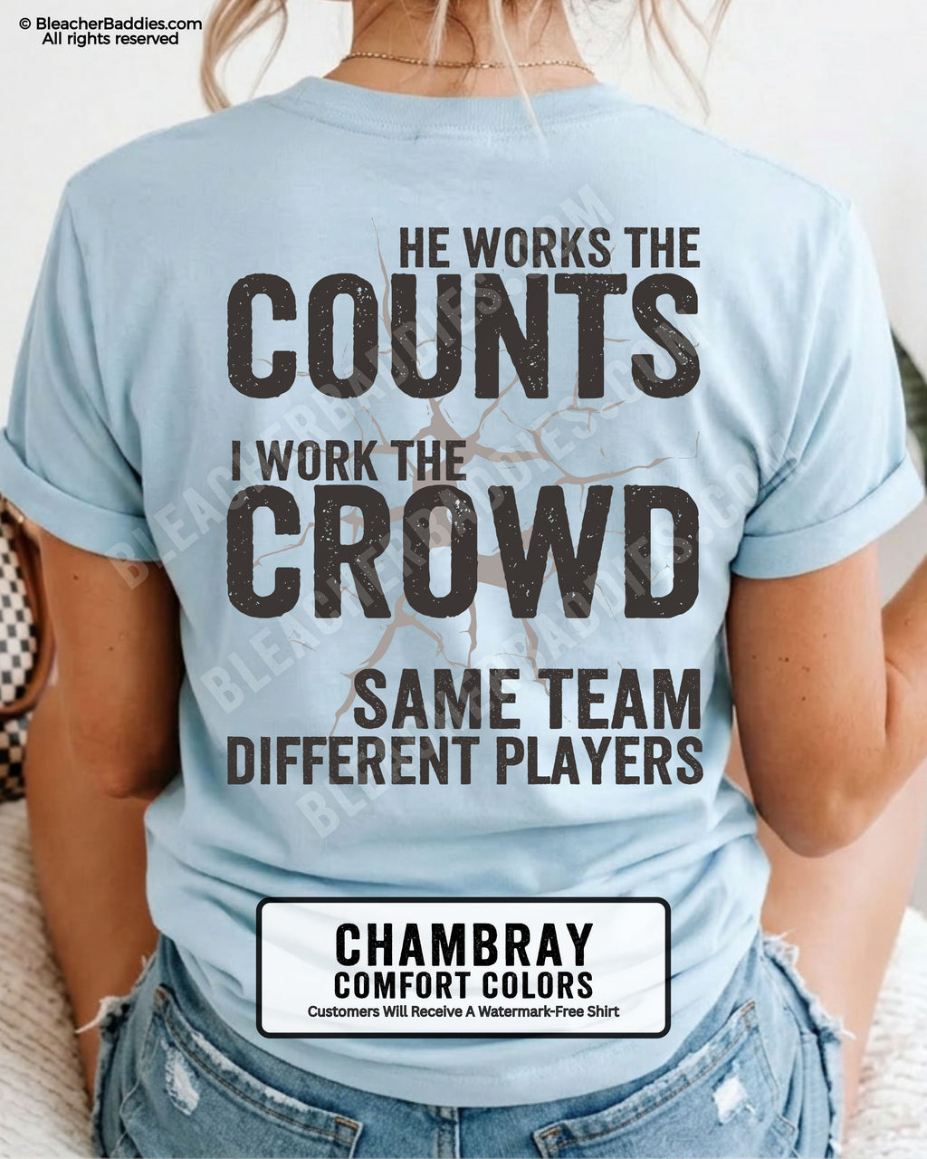 Chambray blue baseball mom graphic tee with distressed oversized lettering reading “He Works The Counts I Work The Crowd Same Team Different Players” across the back