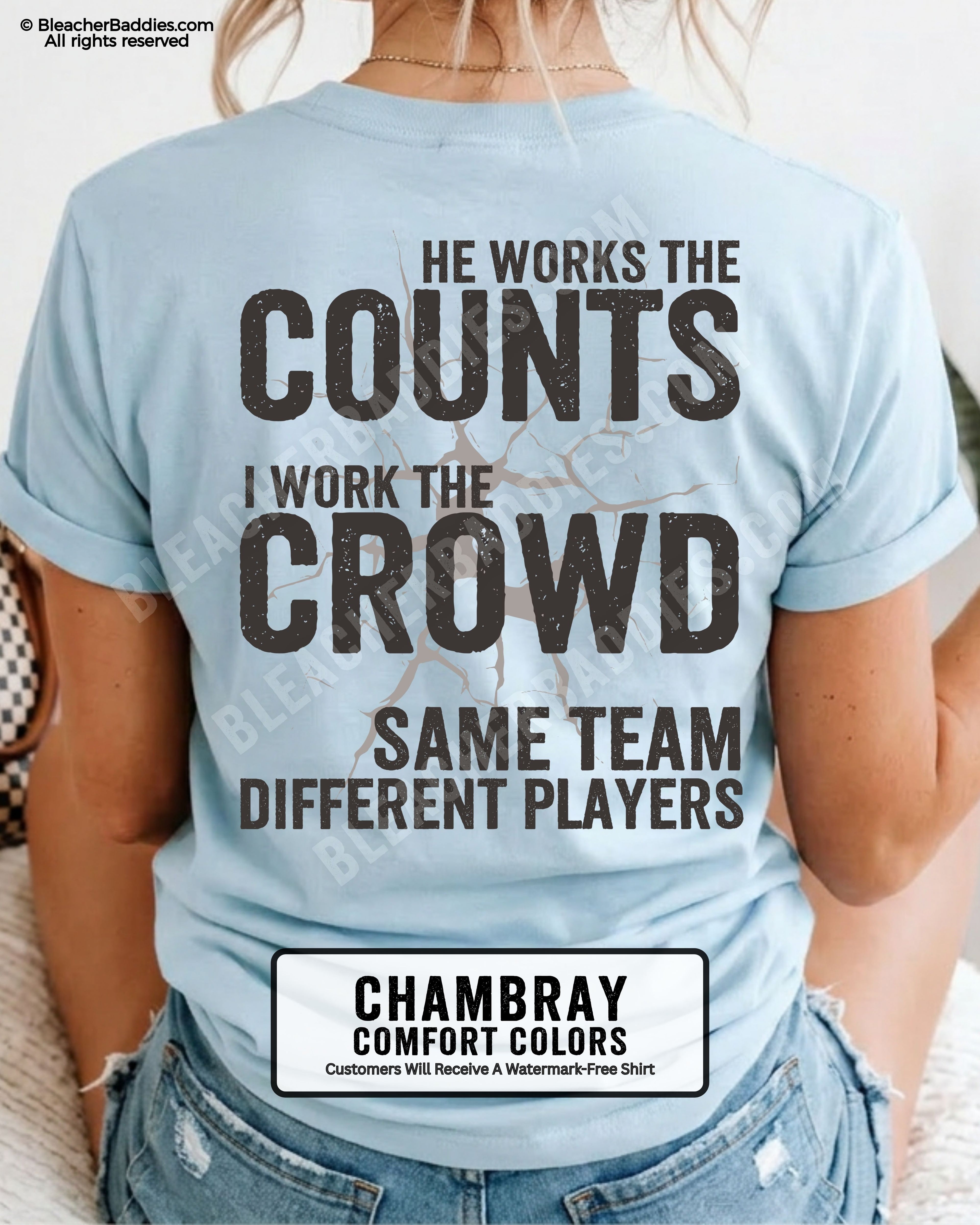Chambray blue baseball mom graphic tee with distressed oversized lettering reading “He Works The Counts I Work The Crowd Same Team Different Players” across the back