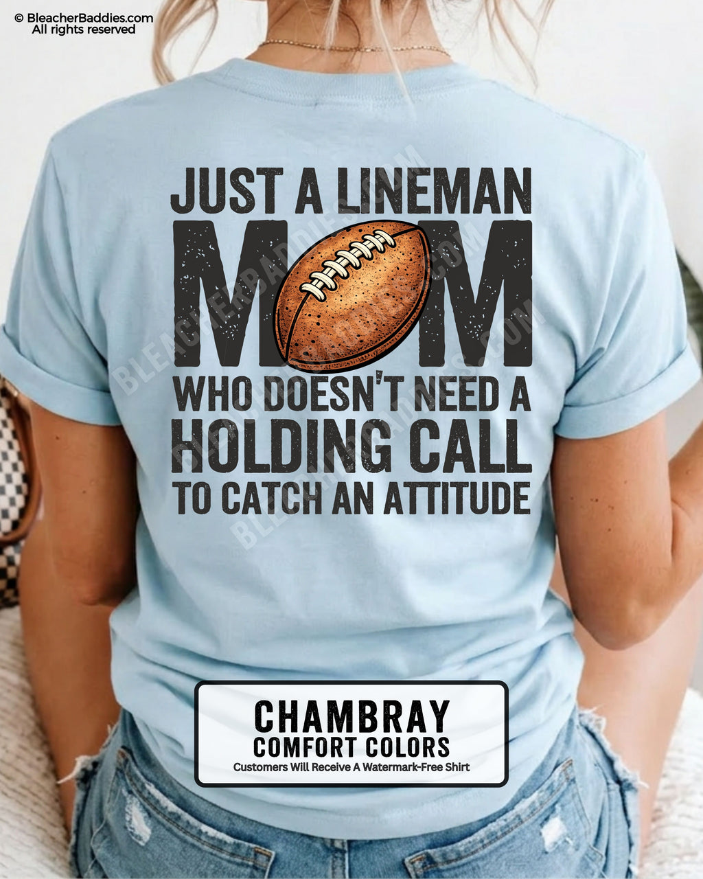 back view of woman wearing a chambray Comfort Colors lineman mom football shirt featuring bold back design that says “Just a lineman mom who doesn’t need a holding call to catch an attitude”