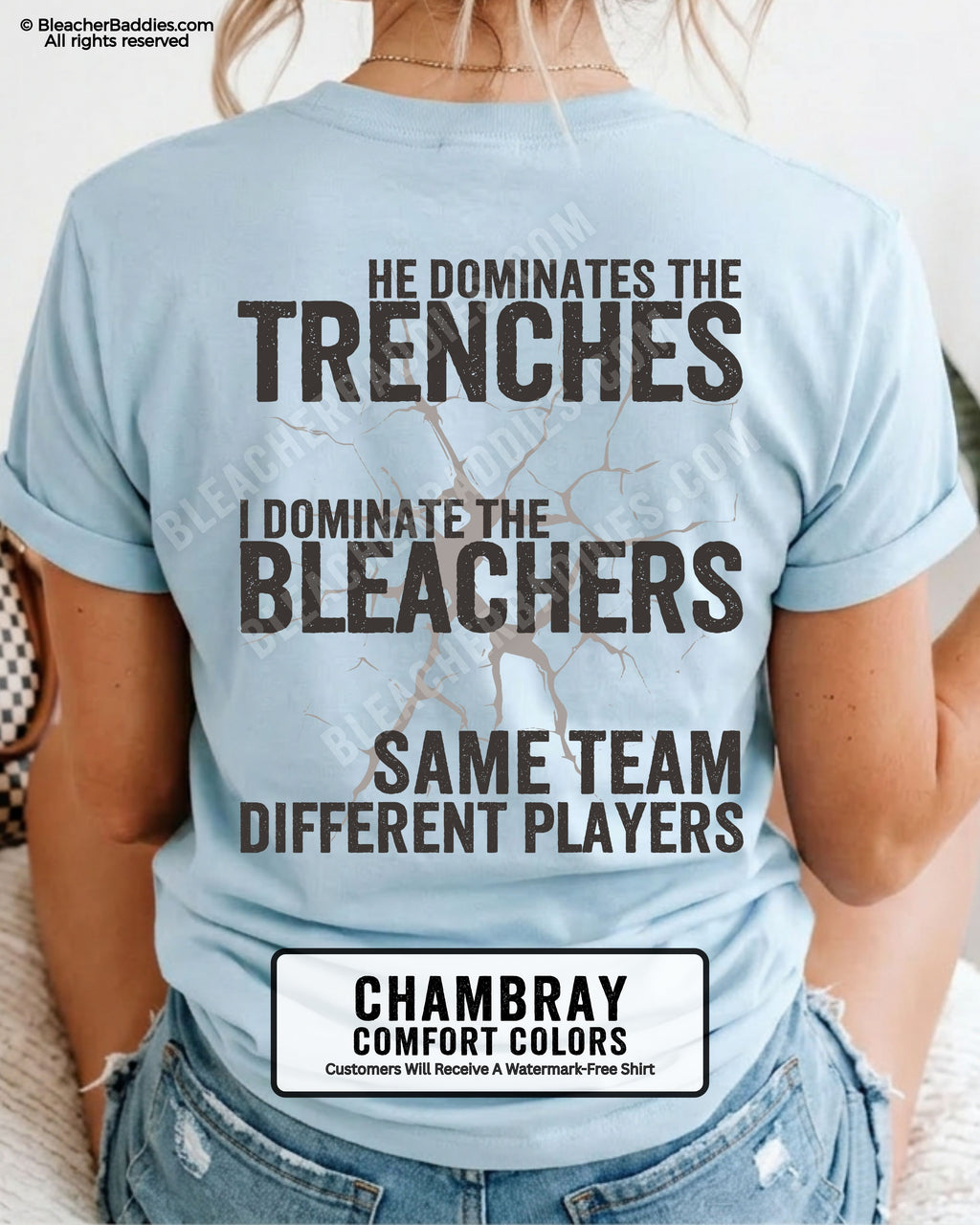 Close-up of woman wearing chambray comfort colors t-shirt back print with distressed text “He Dominates the Trenches I Dominate the Bleachers Same Team Different Players” and cracked design detail