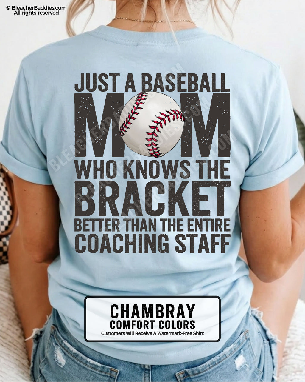 Chambray baseball mom graphic tee featuring distressed black back design reading “Just a baseball mom who knows the bracket better than the entire coaching staff” with baseball illustration centered in MOM