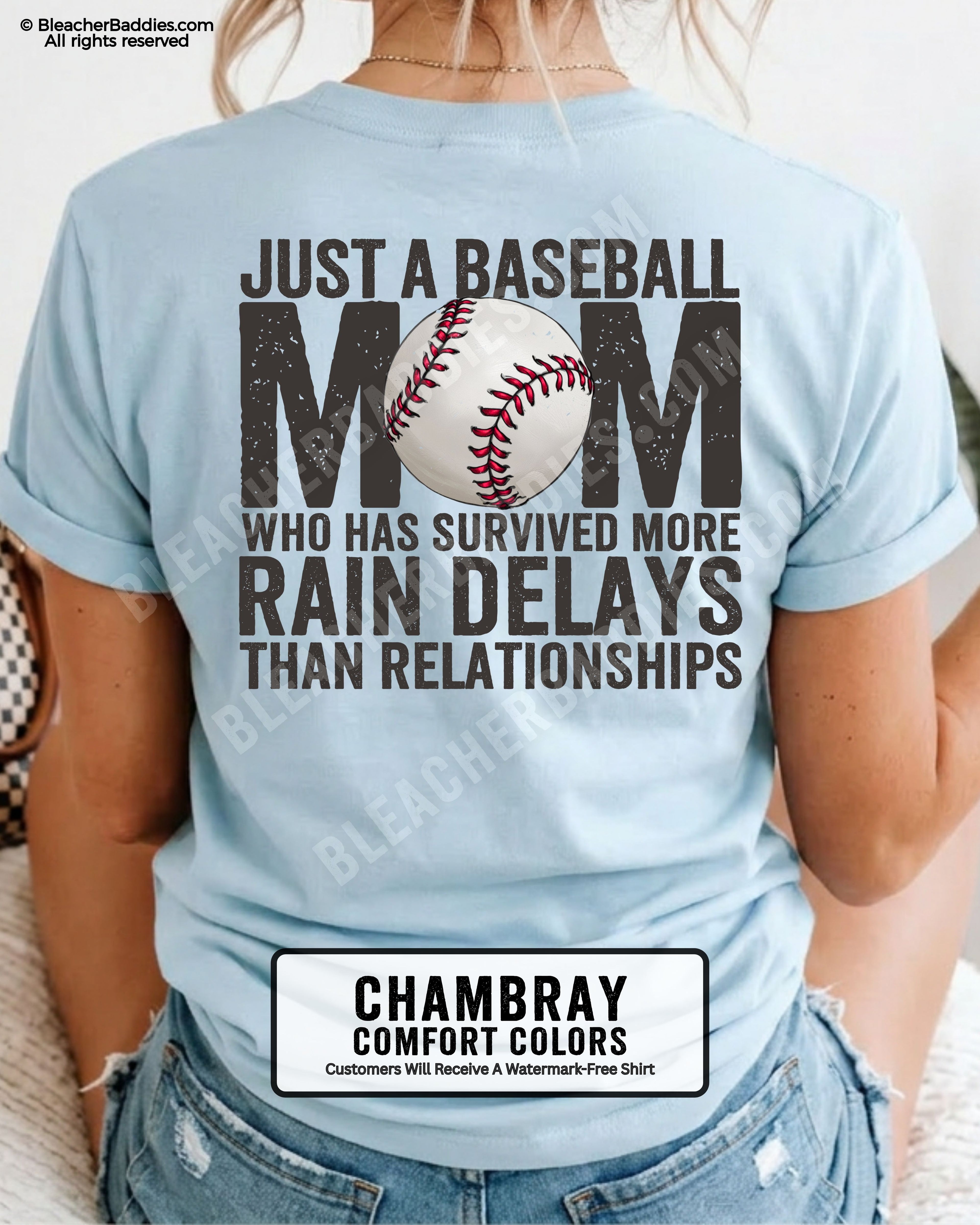 Chambray Comfort Colors game day shirt worn by woman showing distressed back graphic reading “Just a Baseball Mom Who Has Survived More Rain Delays Than Relationships” with baseball illustration over MOM text