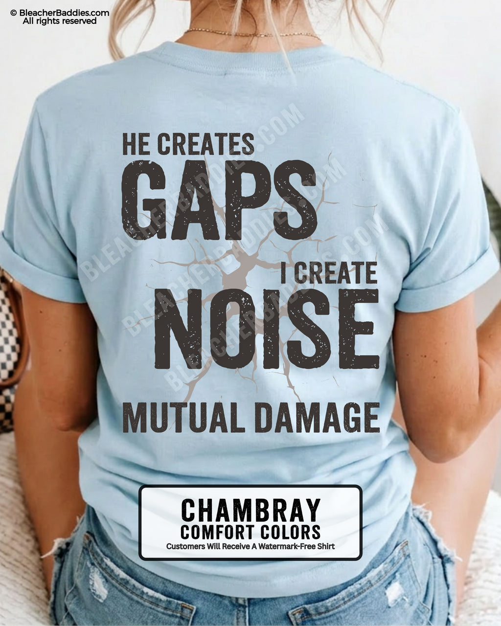 Woman wearing chambray Comfort Colors football mom game day shirt with back design that reads “He creates gaps I create noise mutual damage” in distressed black text with cracked graphic and chambray color label shown