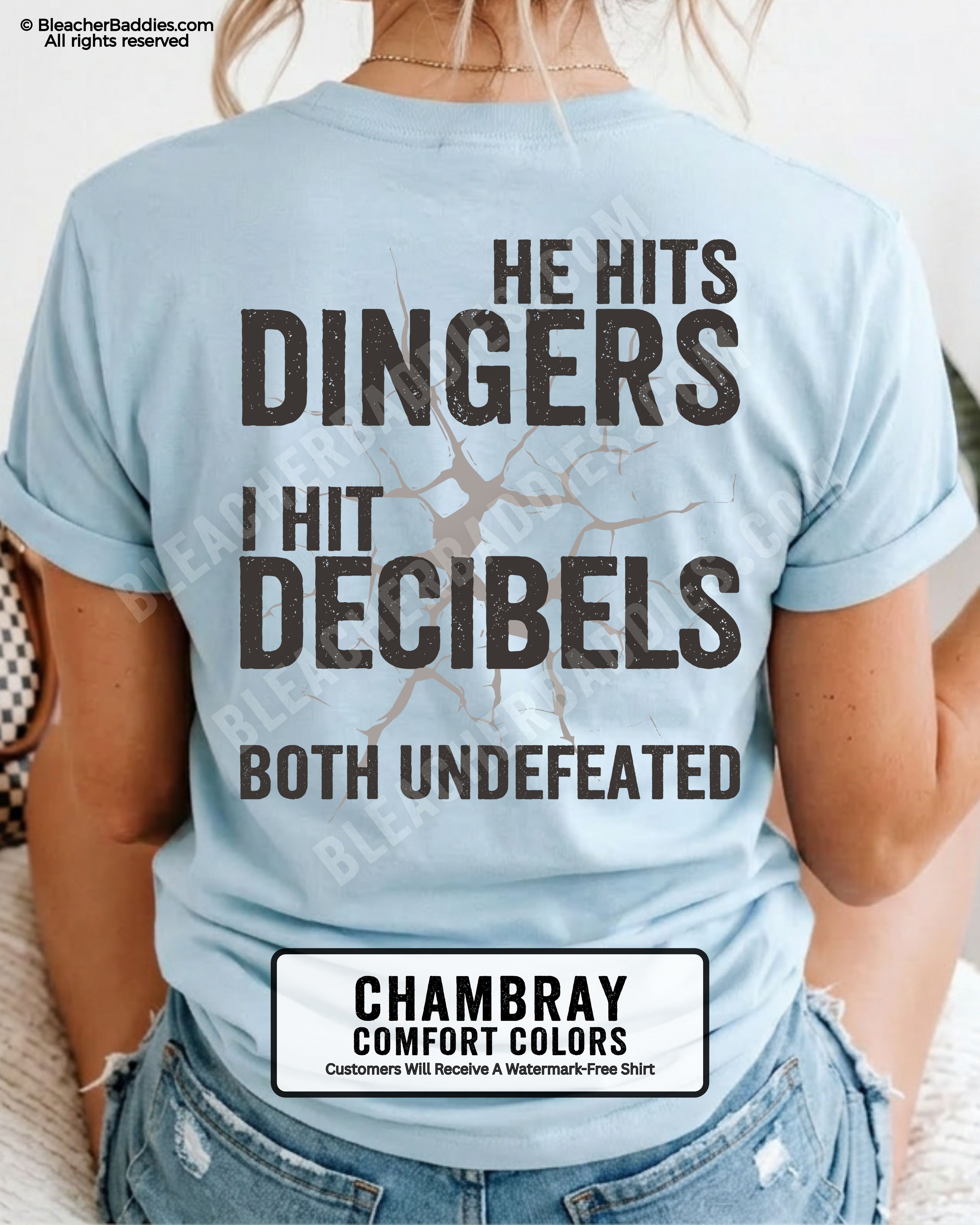 Chambray blue Comfort Colors baseball mom graphic tee with oversized distressed lettering reading “He Hits Dingers I Hit Decibels Both Undefeated” across the back