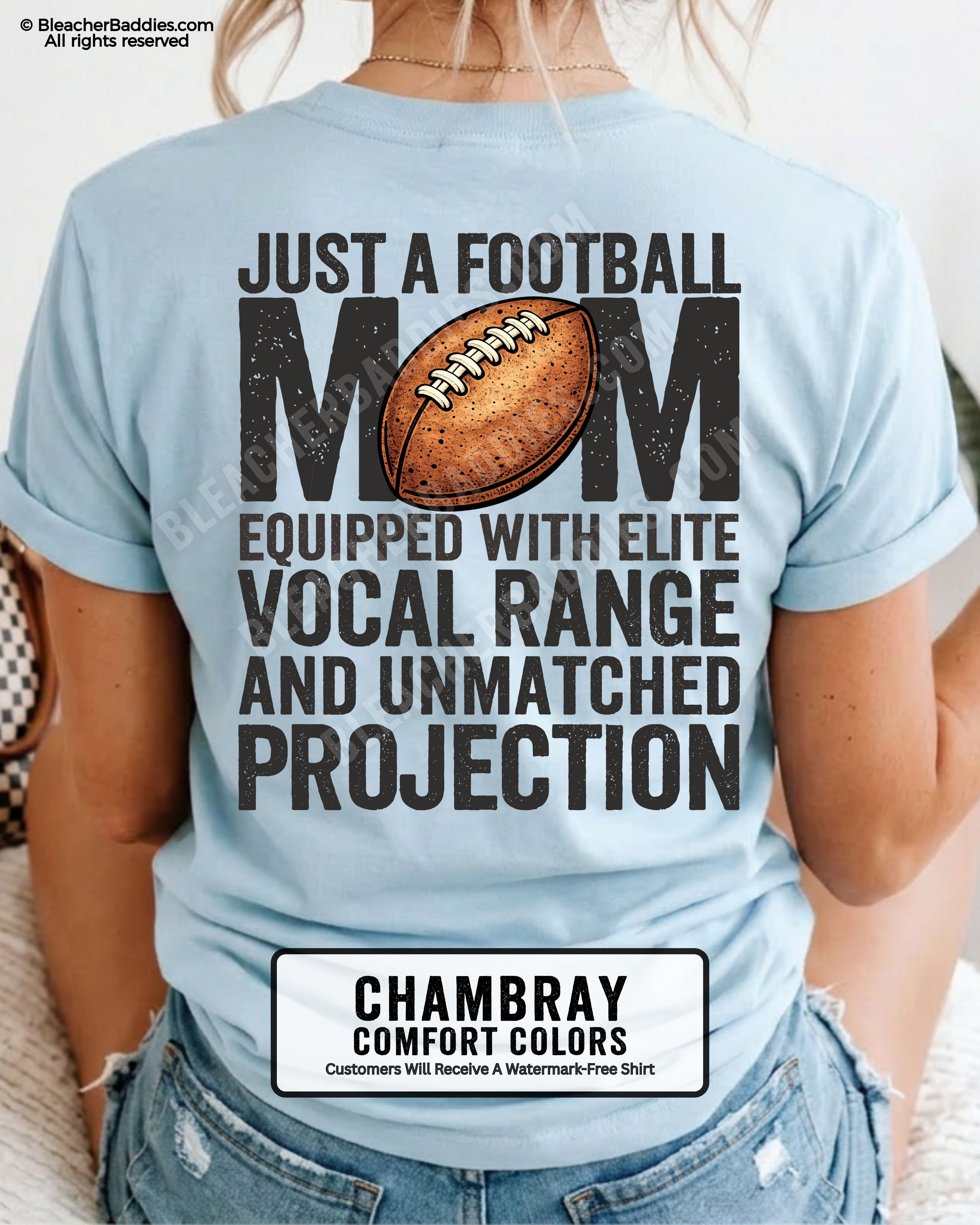 Football mom game day shirt on a chambray Comfort Colors tee, featuring a back graphic that says, “Just a football mom equipped with elite vocal range and unmatched projection.”