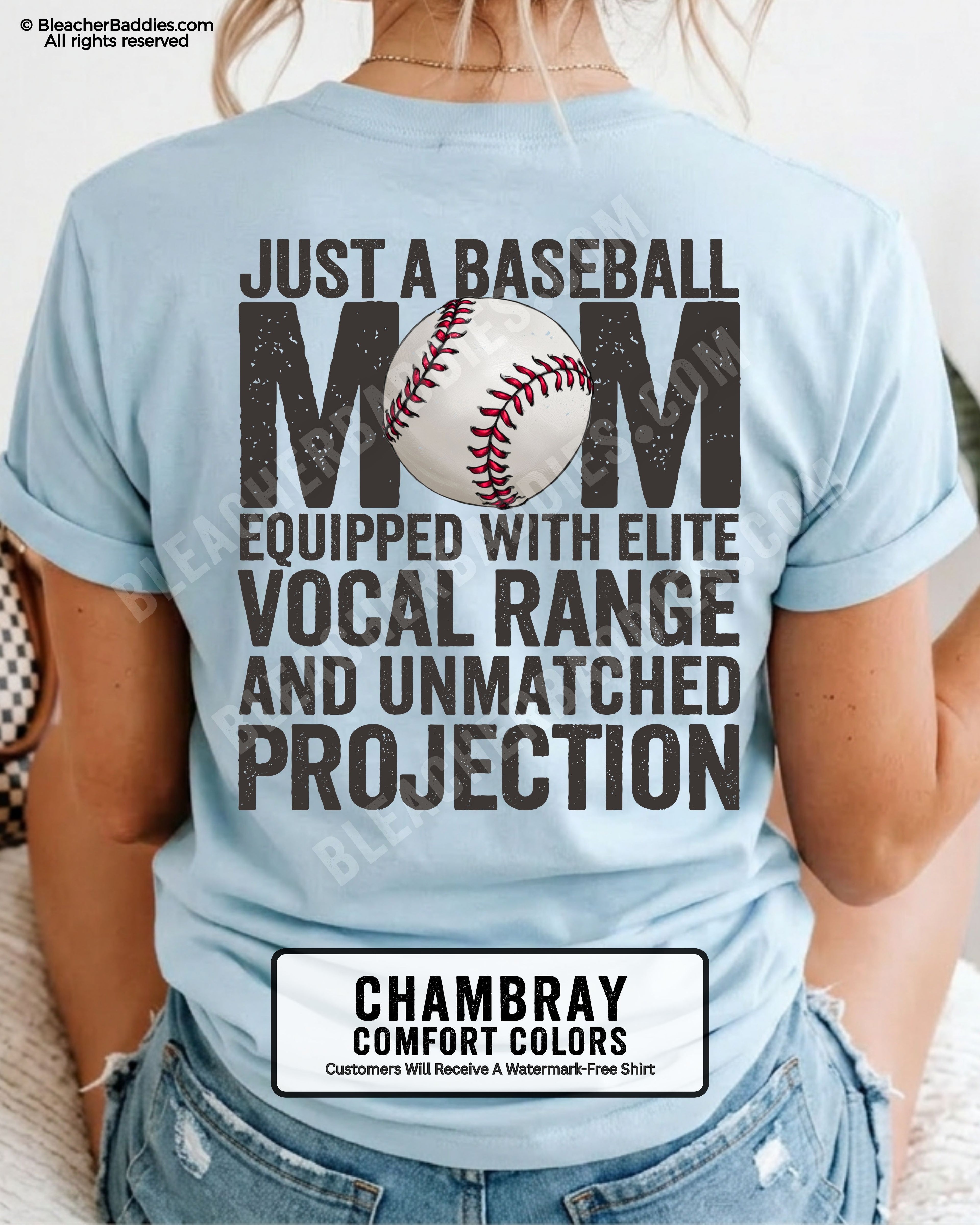 Chambray Comfort Colors game day shirt worn by woman showing distressed back graphic reading “Just a Baseball Mom Equipped With Elite Vocal Range and Unmatched Projection” with baseball illustration over MOM text