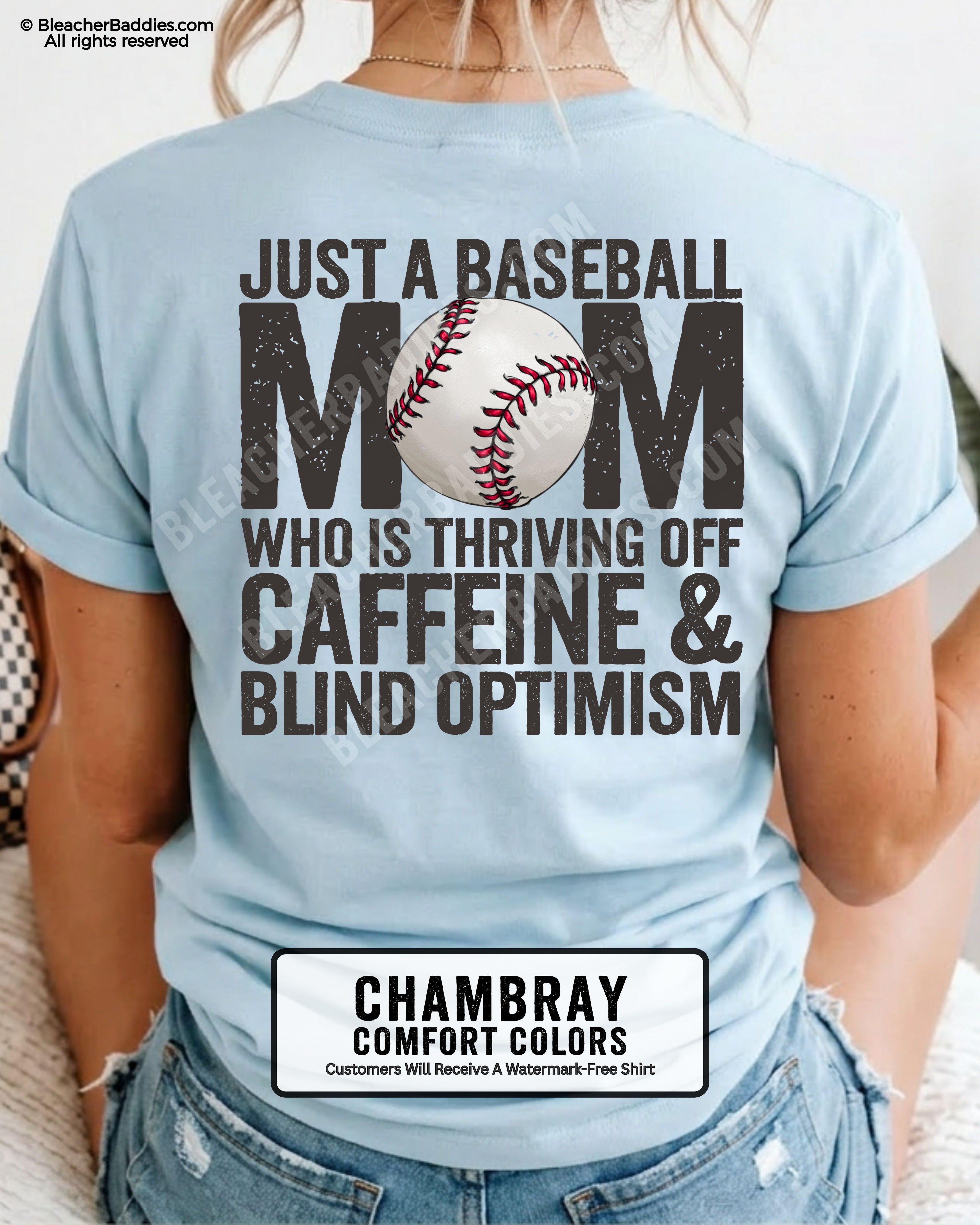 Chambray baseball mom game day shirt with distressed black back graphic reading “Just a baseball mom who is thriving off caffeine and blind optimism” with baseball illustration replacing the O in MOM