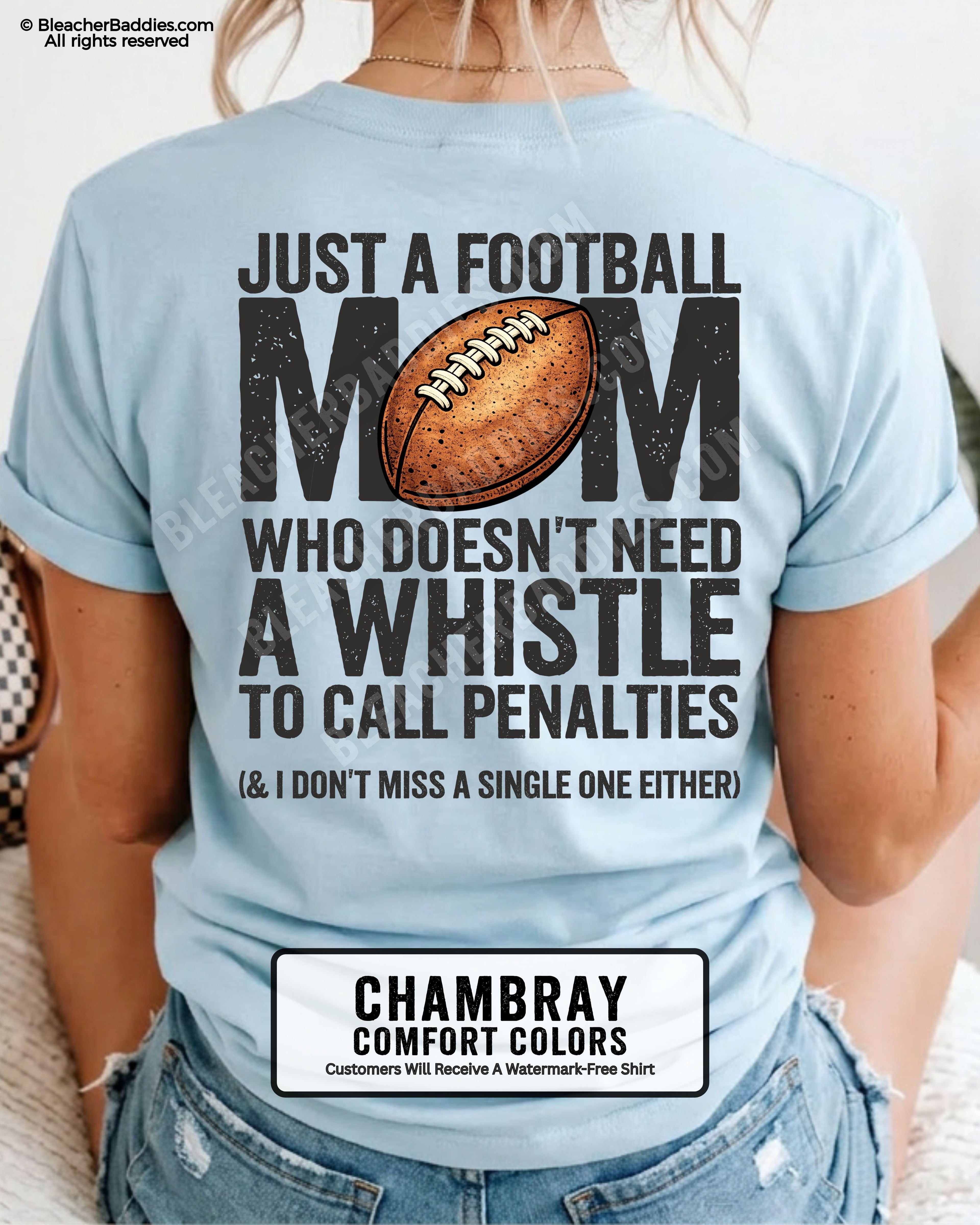 Football mom game day shirt on chambray Comfort Colors tee with bold back graphic that reads “Just a football mom who doesn’t need a whistle to call penalties and I don’t miss a single one either”