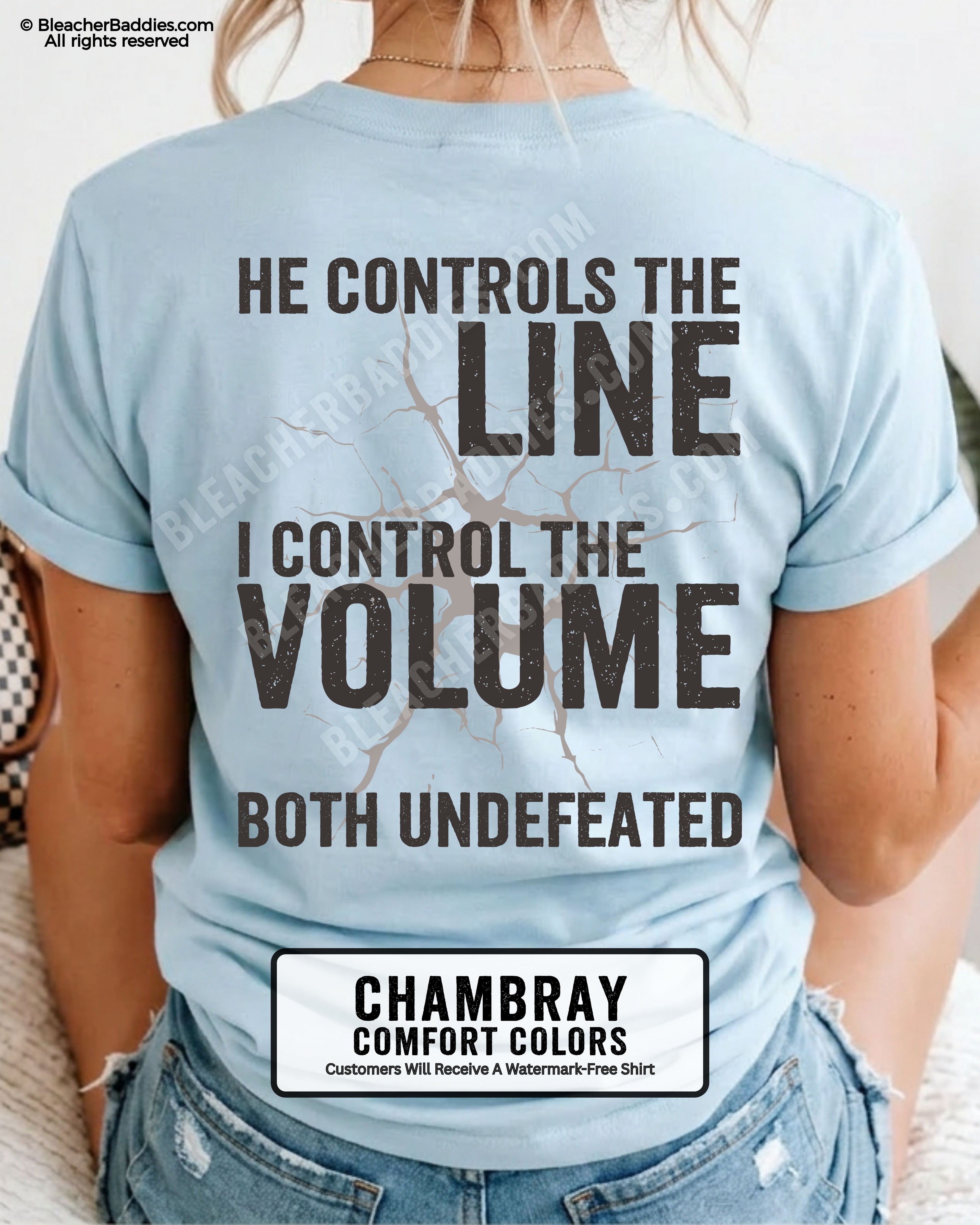 Back view of woman wearing chambray Comfort Colors football mom game day shirt featuring “He Controls the Line I Control the Volume Both Undefeated” bold graphic design