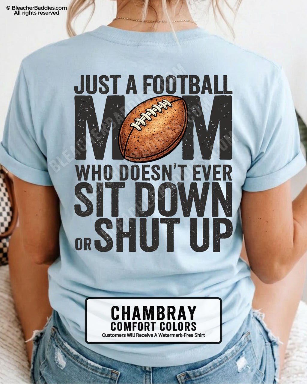 Chambray blue Comfort Colors t-shirt shown from back with oversized graphic text “Just a Football Mom Who Doesn’t Ever Sit Down or Shut Up” and football illustration