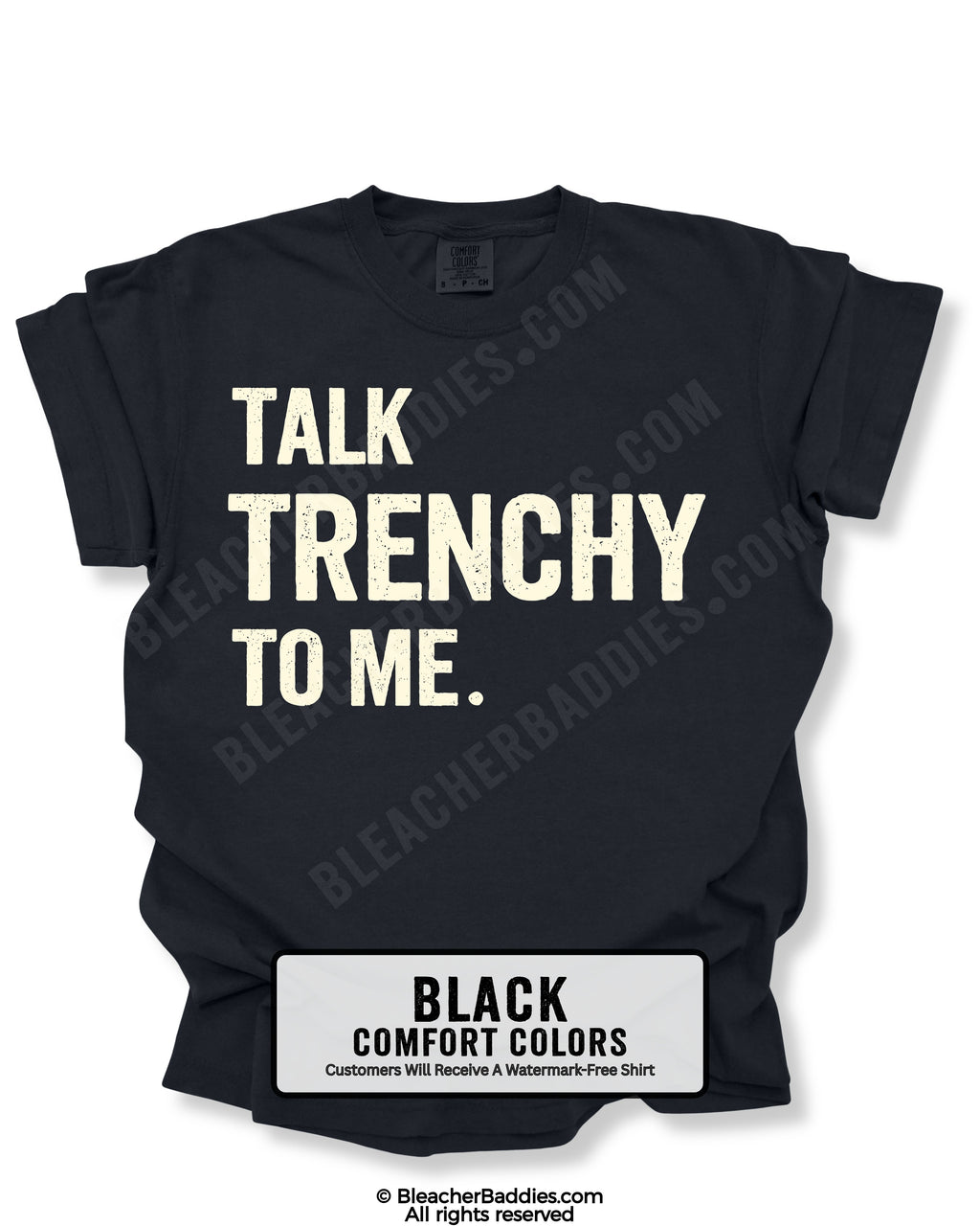 Flat lay of a black Comfort Colors t-shirt featuring the distressed ivory text "TALK TRENCHY TO ME." in large block letters. The shirt is displayed on a white background with rolled sleeves, showcasing a bold football offensive line-inspired graphic perfect for linemen, football players, coaches, and trench football fans.