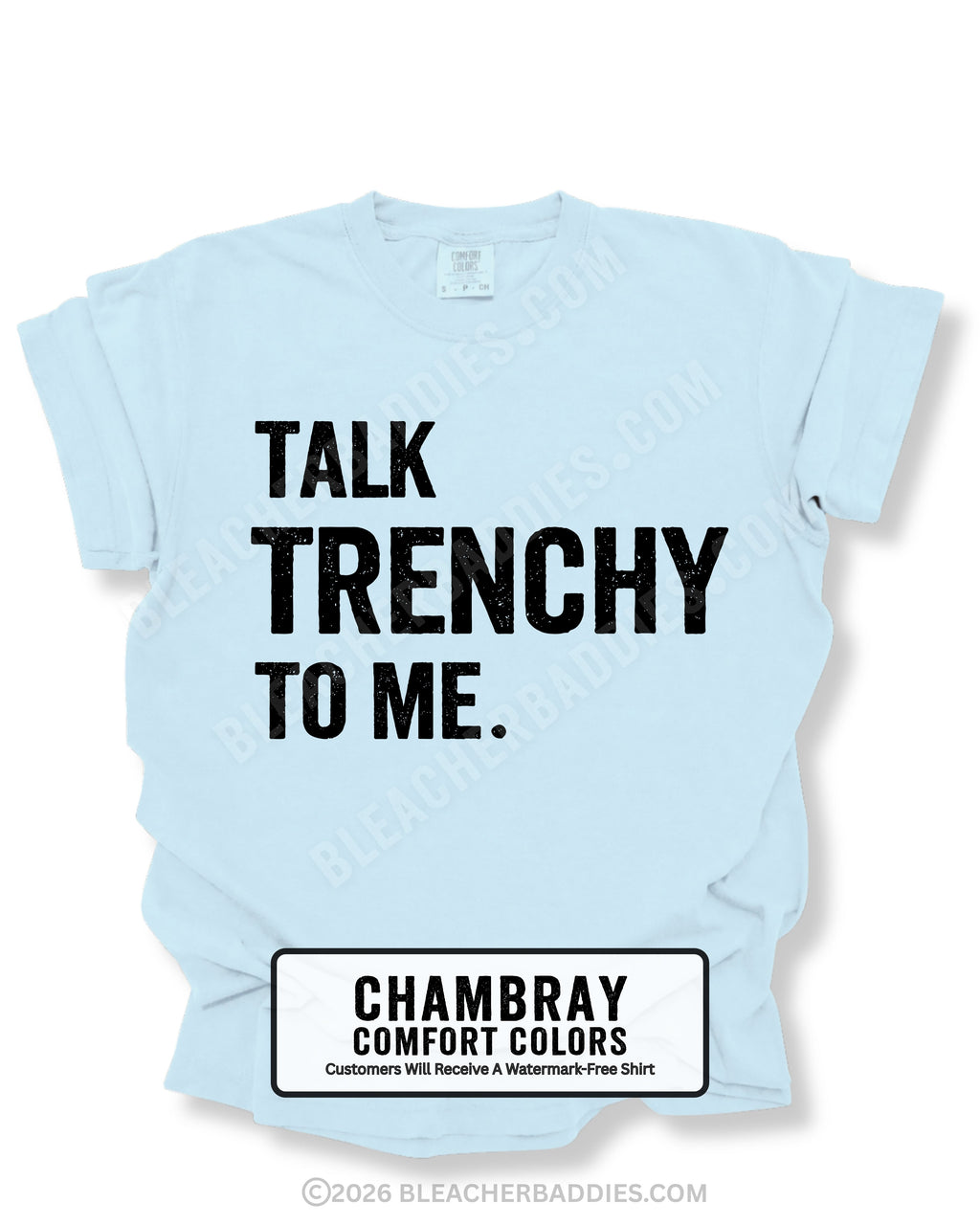 Flat lay of a chambray Comfort Colors t-shirt featuring the distressed black text "TALK TRENCHY TO ME." in large block letters. The shirt is displayed on a white background with rolled sleeves, showcasing a bold football offensive line-inspired graphic perfect for linemen, football players, coaches, and trench football fans.