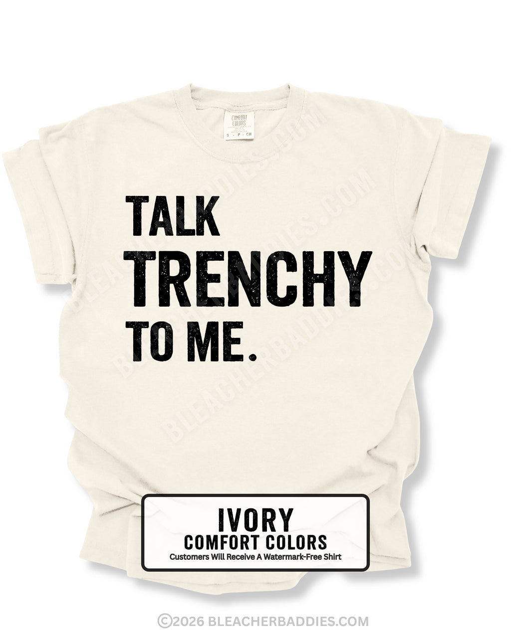 Flat lay of an ivory Comfort Colors t-shirt featuring the distressed black text "TALK TRENCHY TO ME." in large block letters. The shirt is displayed on a white background with rolled sleeves, showcasing a bold football offensive line-inspired graphic perfect for linemen, football players, coaches, and trench football fans.