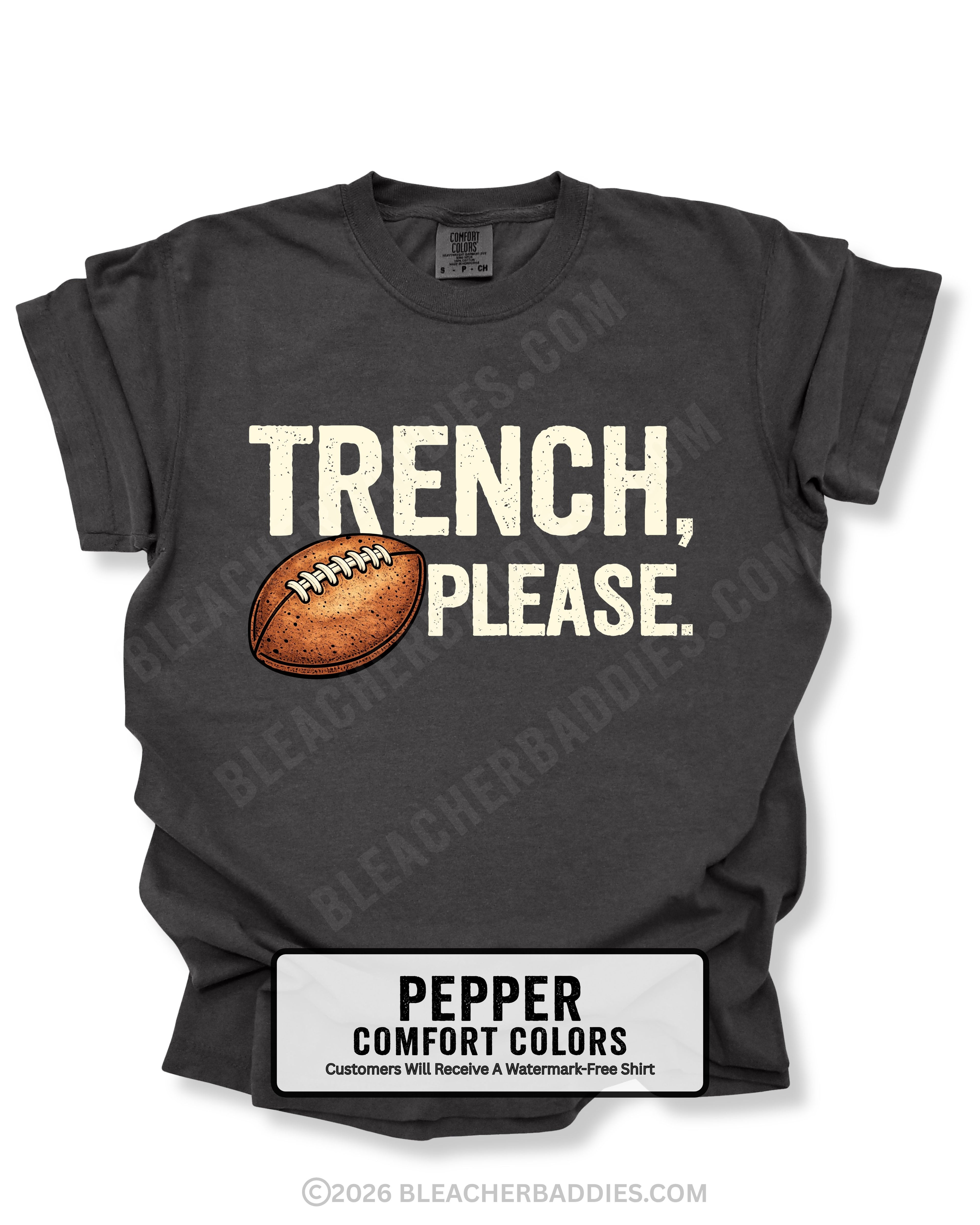Flat lay mockup of a pepper Comfort Colors t-shirt featuring the funny football saying "Trench, Please." in distressed cream lettering with a vintage football graphic. A humorous game day shirt for football fans, offensive line supporters, linemen, coaches, football moms, and anyone who knows the trenches are where games are won.
