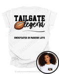White football mom game day shirt featuring “Tailgate Legend” football graphic with the phrase “Undefeated in Parking Lots.” Large back graphic design on shirt with small circular insert showing front chest football mom graphic.