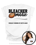 Back of white shirt showing the “Bleacher Baddie” design with a football graphic and the phrase “Probably Running My Mouth Again.” Image includes a circular inset showing the front pocket design reading “Football Mom” with a football graphic.