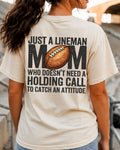 Woman wearing ivory Comfort Colors lineman mom football game day shirt with back print that says “Just a lineman mom who doesn’t need a holding call to catch an attitude”