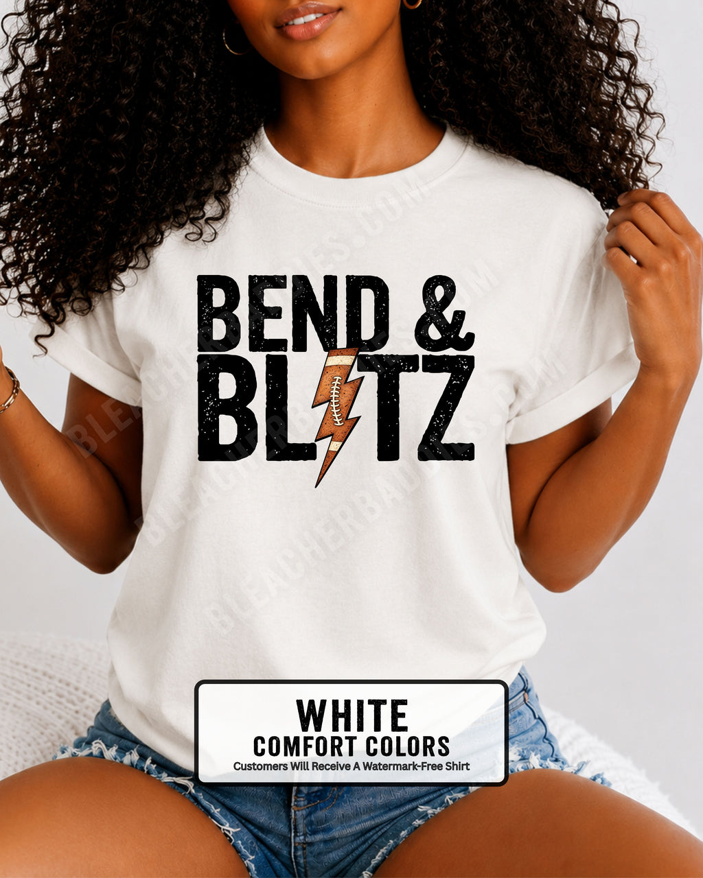 Close-up lifestyle photo of a football mom wearing a white Comfort Colors t-shirt with the distressed black graphic "BEND & BLITZ" and a football lightning bolt design between the words. 